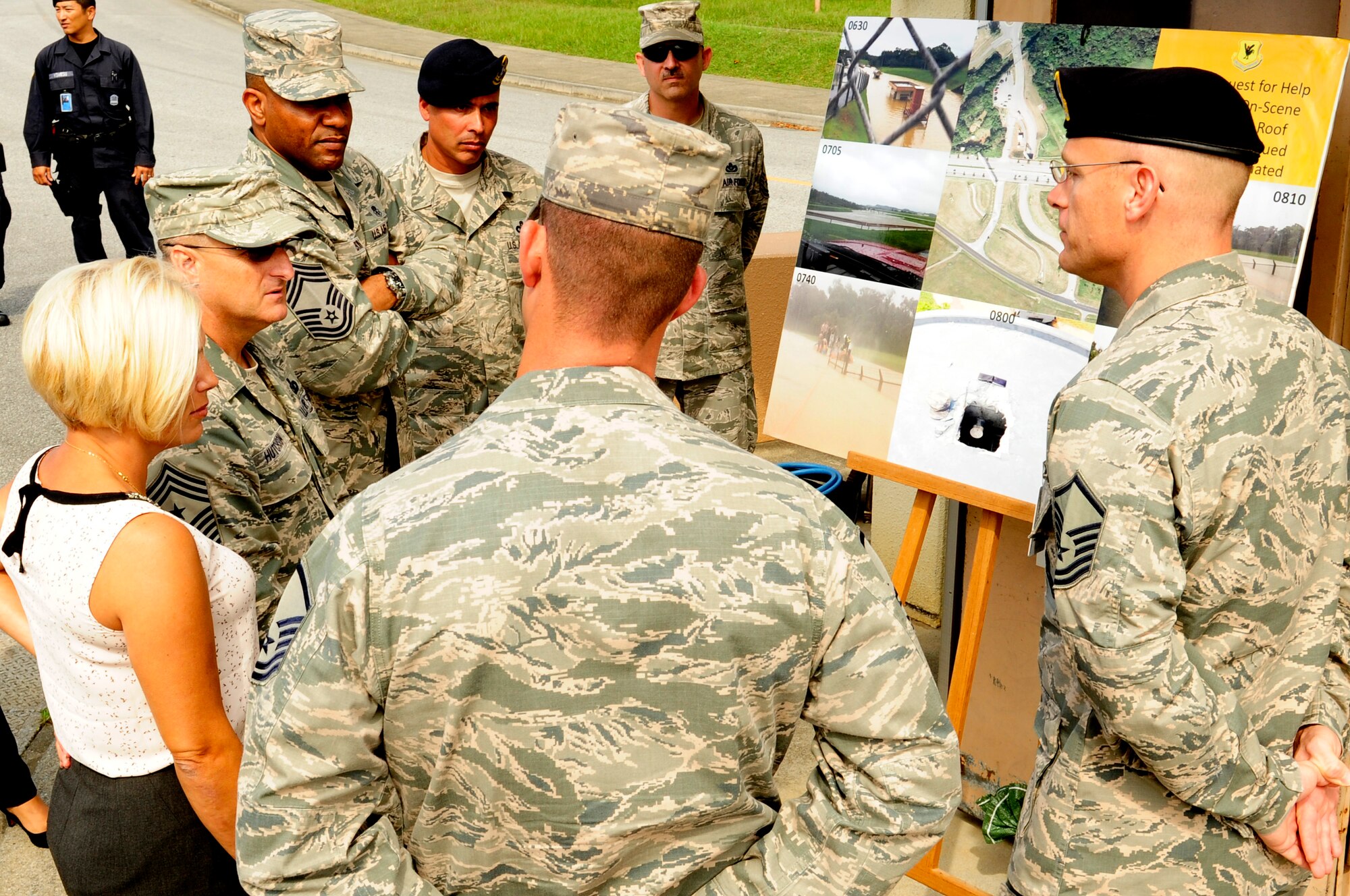 U.S. Air Force Chief Master Sgt. Harold Hutchison, Pacific Air Forces command chief, tours the site of a water rescue by 18th Wing first responders during Typhoon Neoguri on Kadena Air Base, Japan, Oct. 27, 2014. Hutchison was able to meet the first responders who contributed in saving the two Airmen from the flooded guard shack on July 9, 2014. (U.S. Air Force photo by Airman 1st Class Keith James/Released)