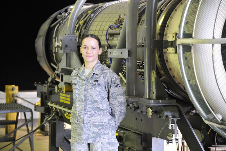 U.S. Air Force Senior Airman Brittney Rogerson, 35th Maintenance Group test cell technician, stands in front an F-16 Fighting Falcon engine at Misawa Air Base, Japan, Oct. 31, 2014. Rogerson and her team of test cell technicians are the last stop for these engines before they carry out the Wild Weasel mission in the Pacific. (U.S. Air Force photo by Airman 1st Class Patrick S. Ciccarone/Released)