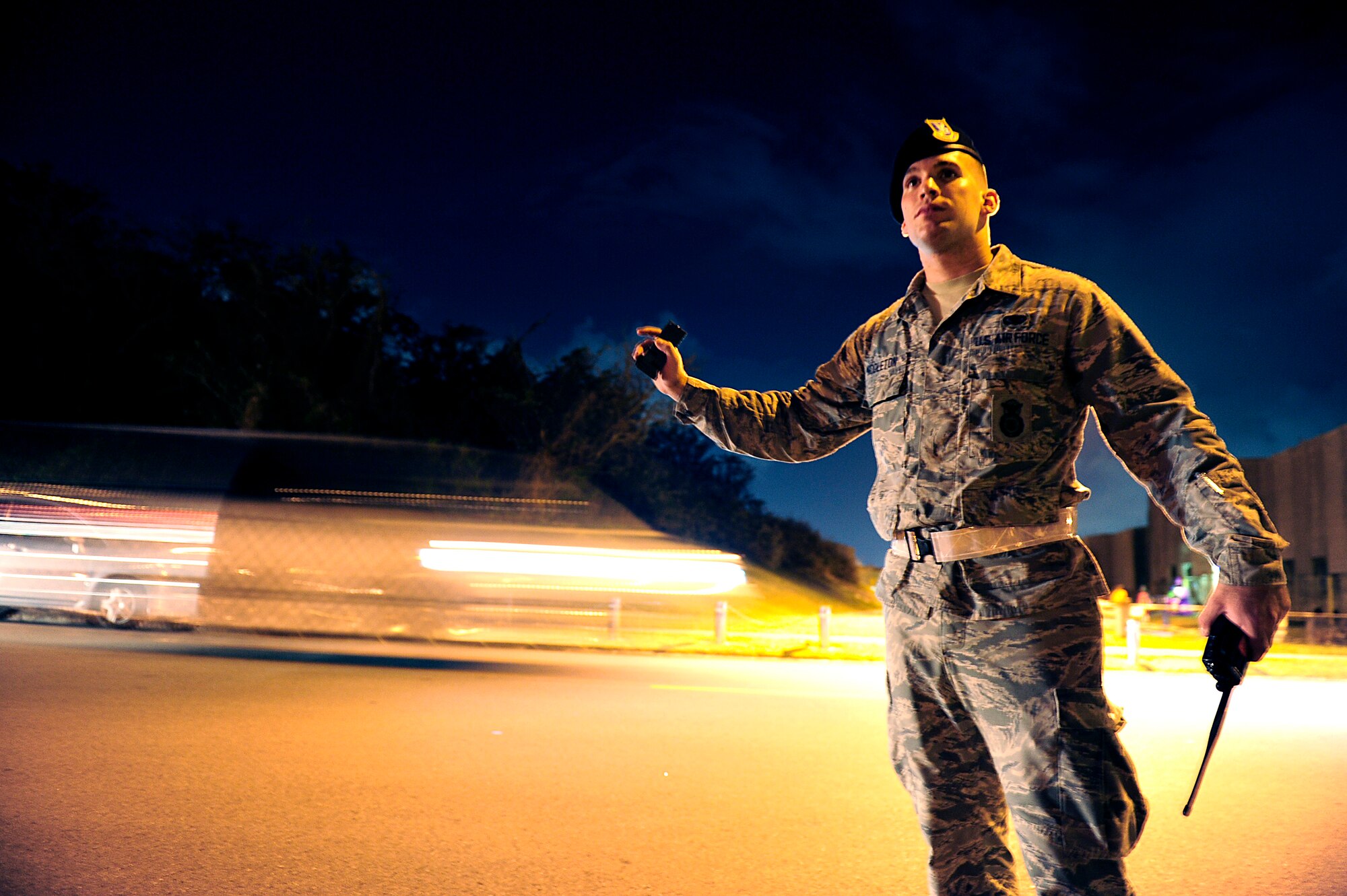 U.S. Air Force Airman 1st Class Blake Middleton, 18th Security Forces Squadron response force member, directs traffic during Halloween trick-or-treating on Kadena Air Base, Japan, Oct. 31, 2014. Each year, Kadena Airmen escort hundreds of local Okinawan children while they trick-or-treat with the American children on base. (U.S. Air Force photo by Senior Airman Maeson L. Elleman)