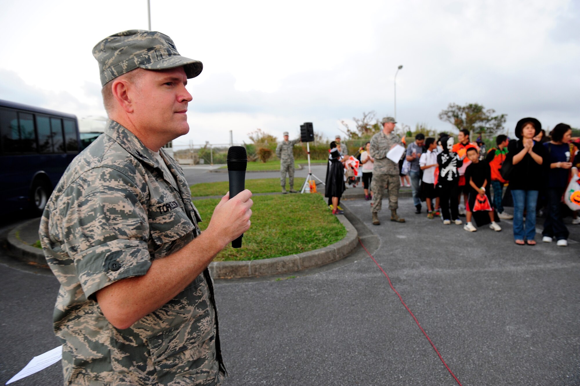 U.S. Air Force Col. Thomas Torkelson, 18th Wing vice commander, speaks to local Okinawan trick-or-treaters before escorting them onto Kadena Air Base, Japan, for Halloween festivities Oct. 31, 2014. More than 420 local Okinawans were invited onto the base Halloween night as part of a partnership with the Air Force stationed here. Events like these promote good neighbor relations and help bolster international ties between the U.S. and Japanese on the island. (U.S. Air Force photo by Senior Airman Maeson L. Elleman)