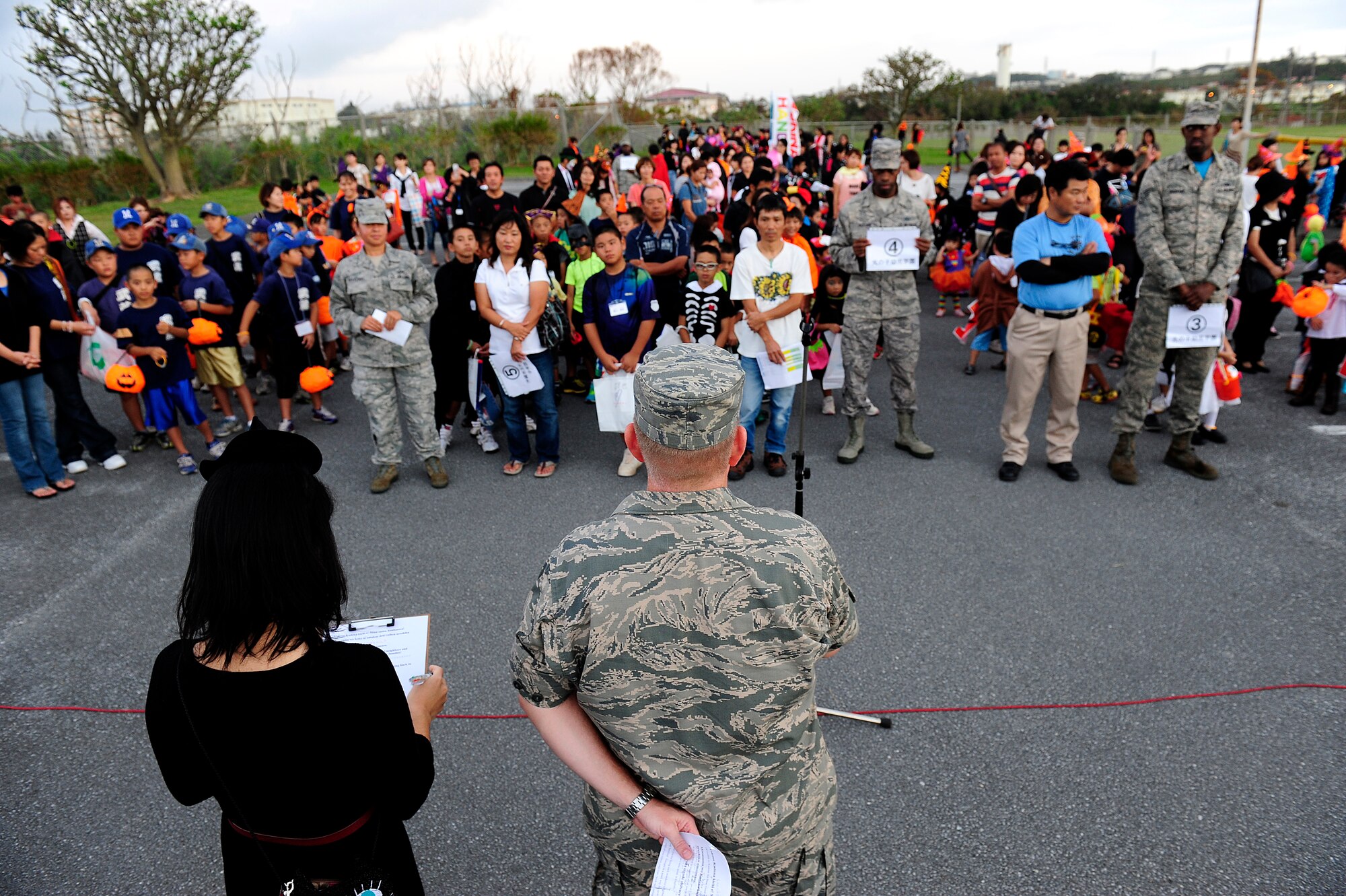 U.S. Air Force Col. Thomas Torkelson, 18th Wing vice commander, speaks to local Okinawan trick-or-treaters before escorting them onto Kadena Air Base, Japan, for Halloween festivities Oct. 31, 2014. More than 420 local Okinawans were invited onto the base Halloween night as part of a partnership with the Air Force stationed here. Events like these are the Air Force's way of giving back to the local community on the island. (U.S. Air Force photo by Senior Airman Maeson L. Elleman)