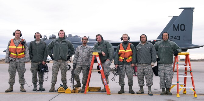 Airmen pose for a picture after ensuring a safe take off for the F-15E Strike Eagle at Mountain Home Air Force Base, Idaho, Nov. 4, 2014. The base is participating in the Capstone training event until Nov. 7, 2014. (U.S. Air Force photo by Airman 1st Class Jessica H. Smith/RELEASED)