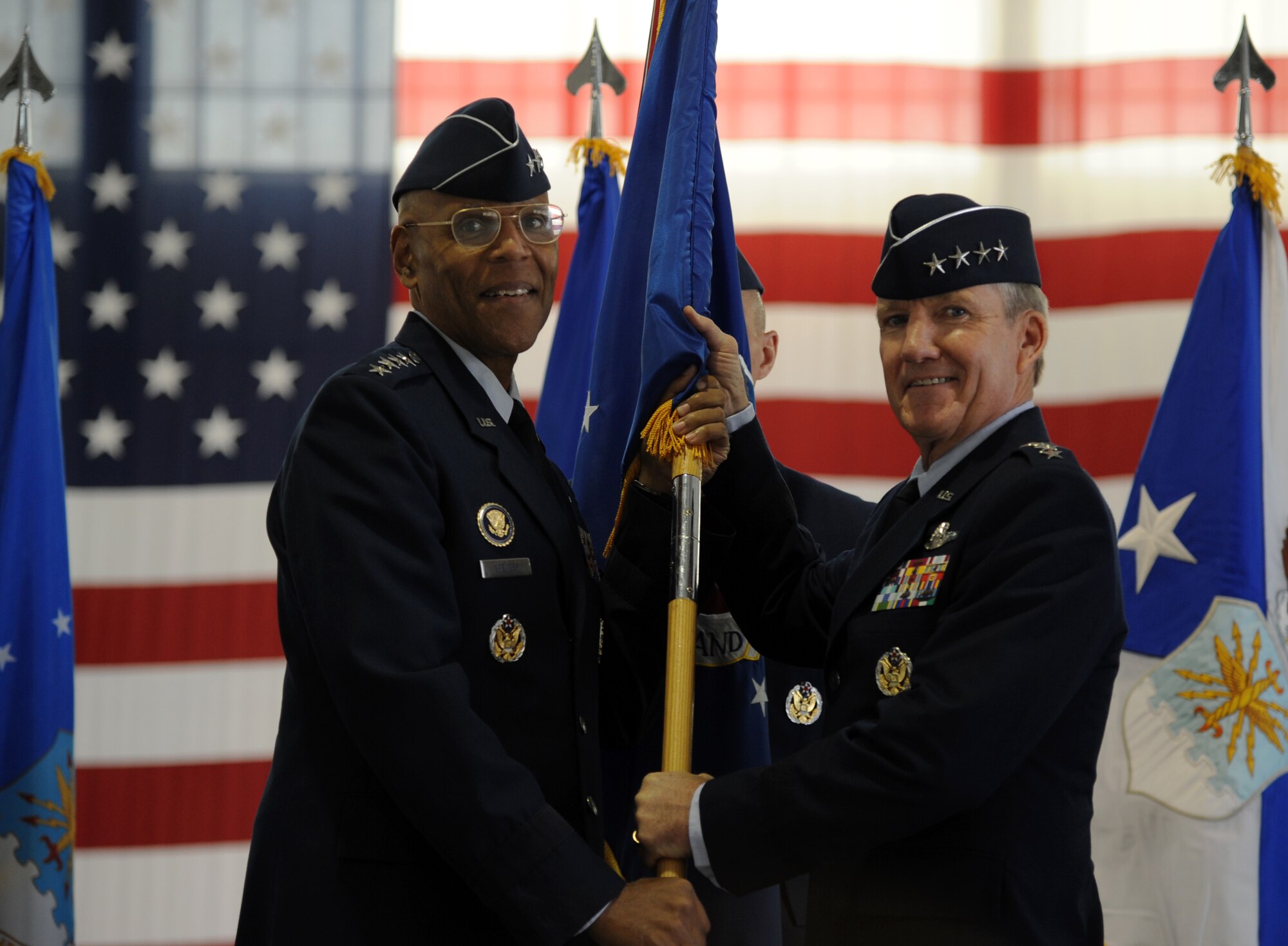 U.S. Air Force Vice Chief of Staff Gen. Larry O. Spencer passes the Air Combat Command guidon to Gen. Hawk Carlisle during ACC’s change of command ceremony at Langley Air Force Base, Va., Nov. 4, 2014. Carlisle assumed command from Gen. Mike Hostage, who retired after 37 years of service to the Air Force. (U.S. Air Force photo by Staff Sgt. Candice Page/Released)