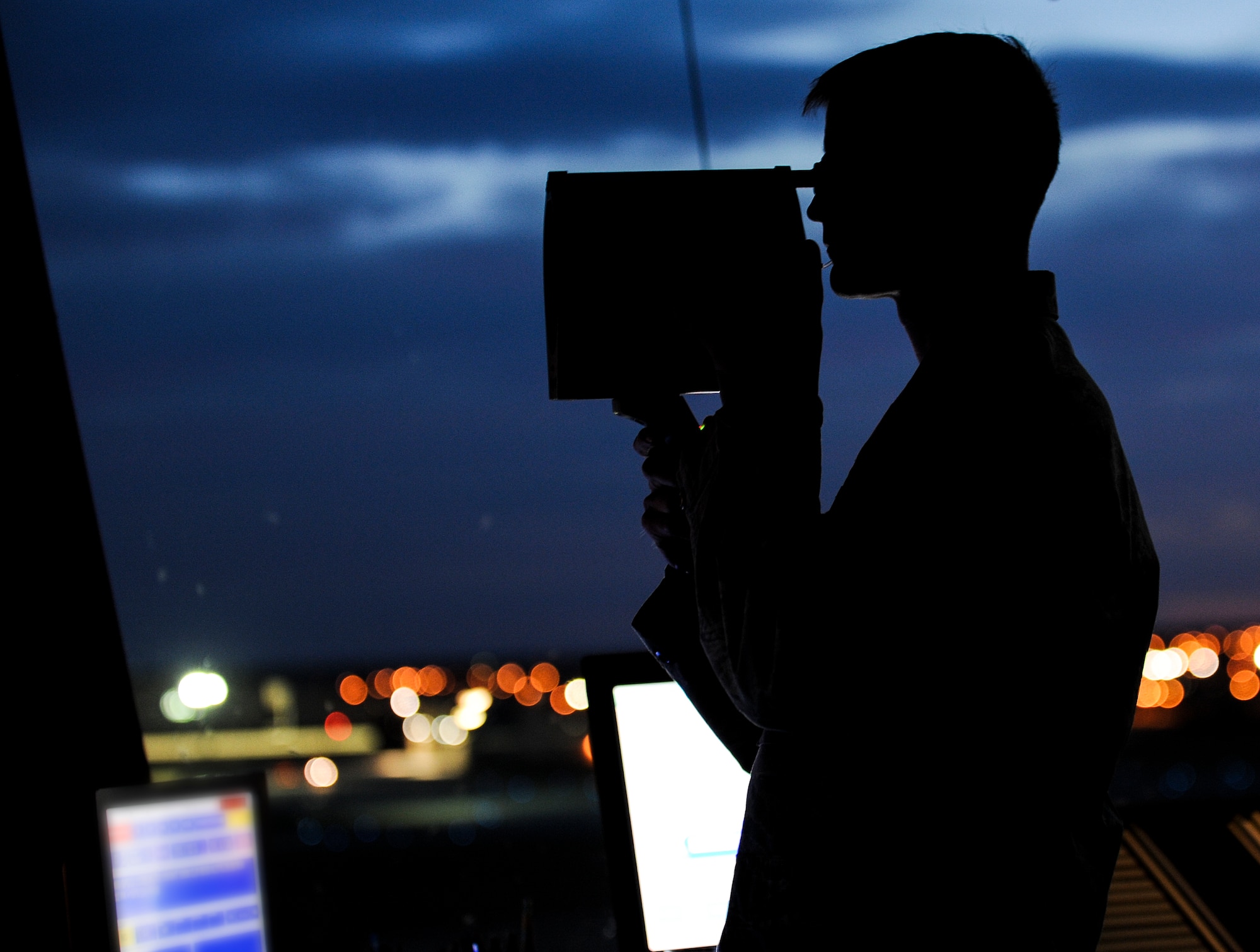 U.S. Air Force Senior Airman Daniel Wichers, a 5th Operations Support Squadron air traffic controller, signals a B-52H Stratofortress with a light gun during Global Thunder 15 at Minot Air Force Base, N.D., Oct. 26, 2014. Light guns are used to convey a variety of messages to pilots. Global Thunder is a U.S. Strategic Command annual field training and battle staff exercise designed to exercise all mission areas with primary emphasis on nuclear command, control and communications. This field training and battle staff exercise provides training opportunities for components, task forces, units, and command posts to deter, and if necessary, defeat a military attack against the United States and to employ forces as directed by the president. (U.S. Air Force photo by Senior Airman Stephanie Morris)