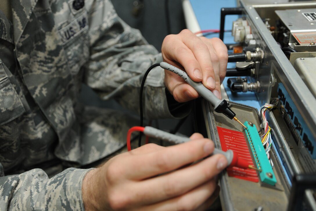 Senior Airman Zachary Saunders, 744 Communication Squadron radio frequency technician, examines a ground-to-air radio receiver at the 744 CS building at Joint Base Andrews, Md., on Aug. 26, 2014. The 744 CS is responsible for land-to-mobile communications, the giant voice and public address system. (U.S. Air Force photo/Airman 1st Class Joshua R. M. Dewberry) 