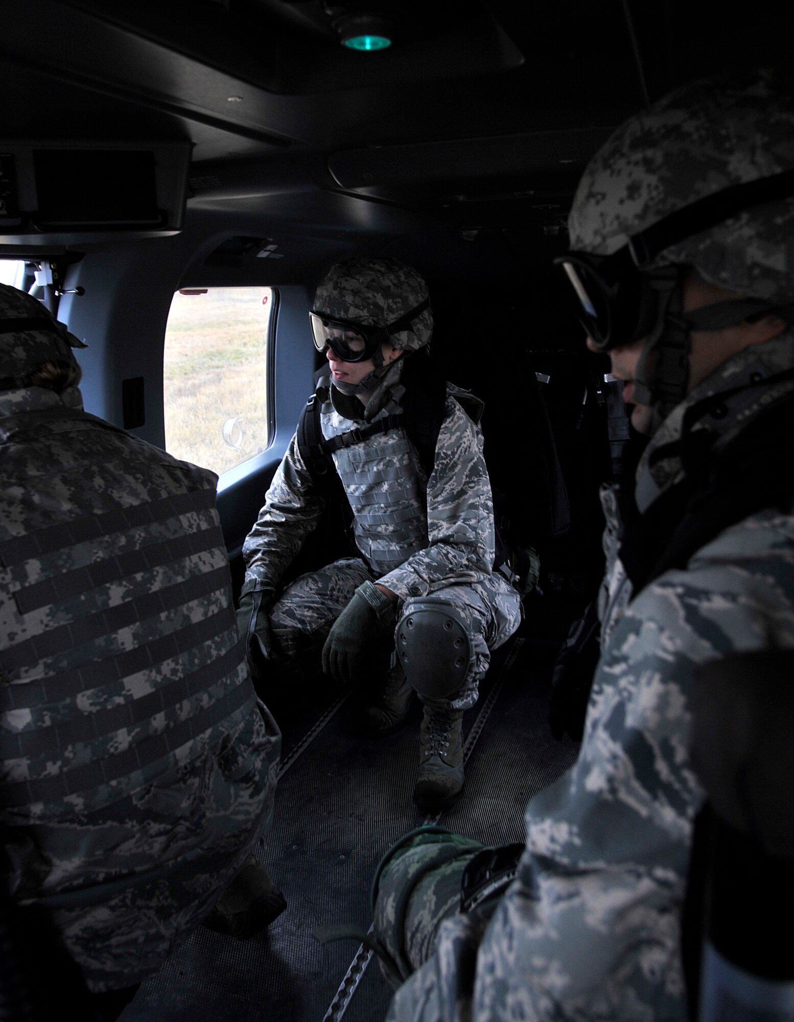 Capt. Kathleen Davenport, 141st Medical Group, prepares to exit a UH-72 Lakota helicopter assigned to the 168th Aviation Regiment during a joint exercise Oct. 31, 2014, at Fairchild Air Force Base, Wash. Davenport was part of a five-man surgical team sent into a simulated combat environment to provide medical assistance to service members in need. (U.S. Air Force photo/Senior Airman Mary O'Dell)