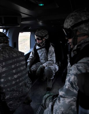 Capt. Kathleen Davenport, 141st Medical Group, prepares to exit a UH-72 Lakota helicopter assigned to the 168th Aviation Regiment during a joint exercise Oct. 31, 2014, at Fairchild Air Force Base, Wash. Davenport was part of a five-man surgical team sent into a simulated combat environment to provide medical assistance to service members in need. (U.S. Air Force photo/Senior Airman Mary O'Dell)
