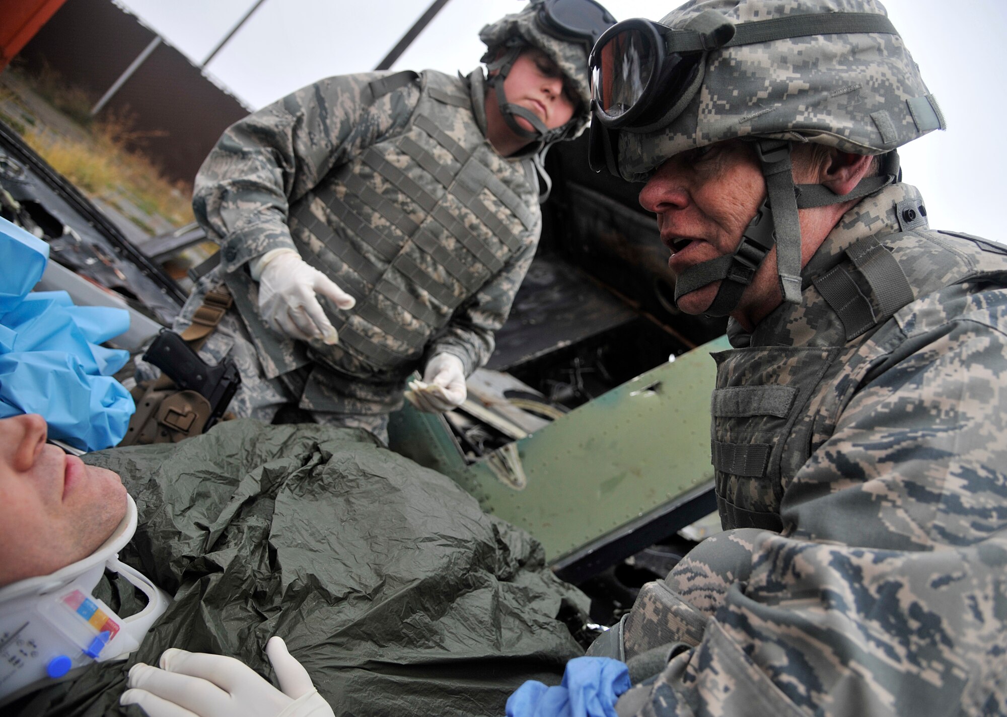 Lt. Col. Charles Floyd, 141st Medical Group, informs a patient he will need a leg amputation during a joint exercise Oct. 31, 2014, at Fairchild Air Force Base, Wash. Floyd acted as the lead surgeon of a five-man team in a simulated combat environment, looking over and operating on each patient as needed. (U.S. Air Force photo/Senior Airman Mary O'Dell)