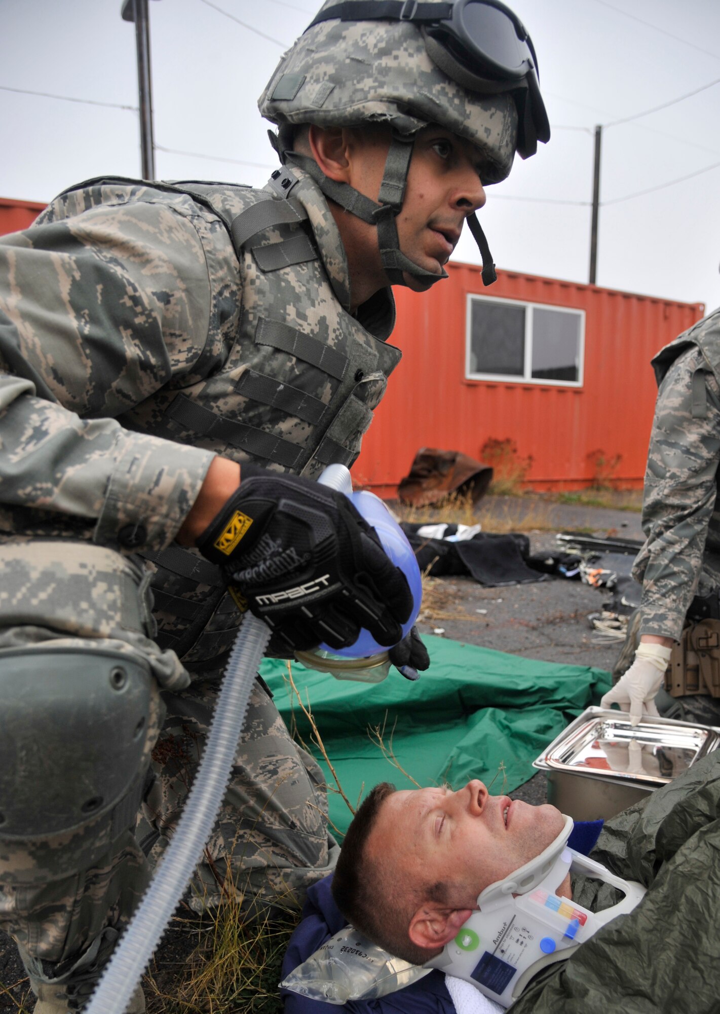 2nd Lt. Richard Cardenas, 141st Medical Group, prepares to administer an anesthetic to a patient requiring an amputation during a joint exercise Oct. 31, 2014, at Fairchild Air Force Base, Wash. Cardenas was part of a five-man surgical team providing assistance to members in a simulated combat environment. This exercise also included soldiers and helicopters from the Army's 168th Aviation Regiment, also stationed at Fairchild. The aircraft dropped them into the zone to provide surgical care to the simulated patients. (U.S. Air Force photo/Senior Airman Mary O'Dell)