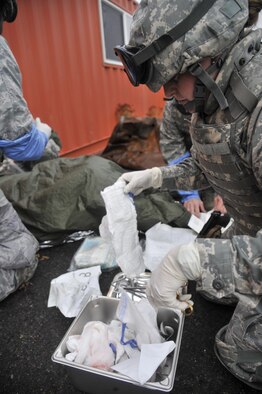 Capt. Amanda Roby, 141st Medical Group, prepares surgical equipment for a patient suffering a simulated liver laceration during a joint exercise Oct. 31, 2014, at Fairchild Air Force Base, Wash. Roby was part of a five-man team assisting members with surgical needs in a simulated combat environment. The exercise also included UH-72 Lakota helicopters, assigned to the Army's 168th Aviation Regiment, which dropped the team into the simulated combat zone. The Lakotas are also stationed at Fairchild. (U.S. Air Force photo/Senior Airman Mary O'Dell)