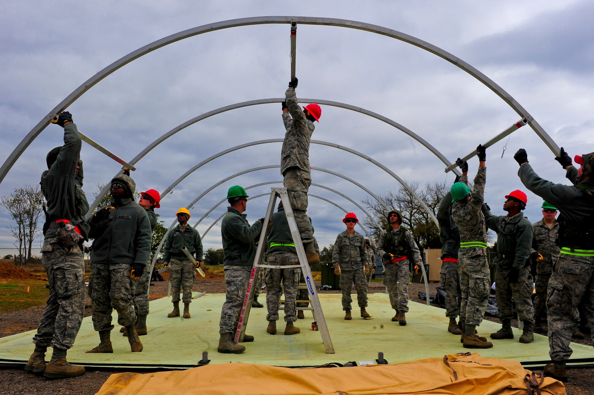 Airmen with the 567th RED HORSE out of Seymour Johnson Air Force Base, North Carolina, construct a tent during a field training exercise at Fort Smith, Arkansas, Nov. 3, 2014. The exercise, also featuring the 560th RED HORSE out of Joint Base Charleston, South Carolina, and Airmen out of the 4th Fighter Wing at Seymour Johnson AFB, is hosting 174 participants to provide upgrade training and prepare for an upcoming operation in support of Beyond the Horizon. Beyond the Horizon, conducted annually, is part of U.S. Army South and U.S. Southern Command’s humanitarian and civic assistance program, which works closely with host-nation forces and civilian organizations to provide medical, dental, and engineering support. (U.S. Air Force photo/Airman 1st Class Brittain Crolley)