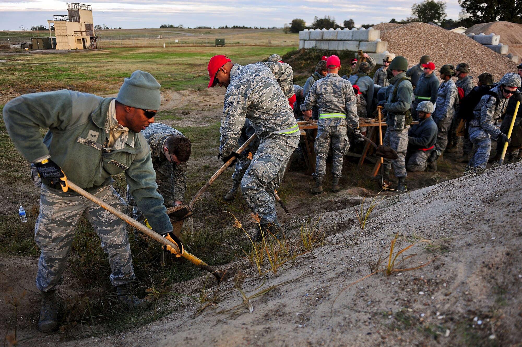 Airmen from the 567th RED HORSE out of Seymour Johnson Air Force Base, North Carolina, fill sandbags during a field training exercise at Fort Smith, Arkansas, Nov. 3, 2014. The weeklong exercise, also featuring the 560th RED HORSE out of Joint Base Charleston, South Carolina, and Airmen out of the 4th Fighter Wing at Seymour Johnson AFB, is hosting 174 participants to provide upgrade training and prepare for an upcoming operation in support of Beyond the Horizon. Beyond the Horizon, conducted annually, is part of U.S. Army South and U.S. Southern Command’s humanitarian and civic assistance program, which works closely with host-nation forces and civilian organizations to provide medical, dental, and engineering support. (U.S. Air Force photo/Airman 1st Class Brittain Crolley)