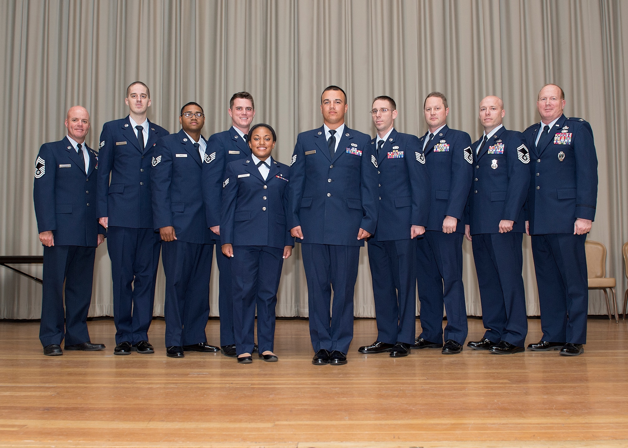 A group of Airmen pose for a photo at the base theater Oct. 31 during the monthly enlisted promotion ceremony. Congratulations to those Airmen who achieved the next step in their careers. (U.S. Air Force photo by Edward Cannon)