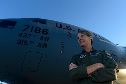 U.S. Air Force Lt. Col. Debi Rieflin, 315th Operation Support Squadron instructor pilot, poses in front of a C-17 Globemaster III before her final (fini) flight Oct. 27, 2014 at Joint Base Charleston, South Carolina. Rieflin is the first female C-17 aircraft commander with 21 years in the aircraft and retiring with 31 years in the Air Force. (U.S. Air Force photo/Senior Airman Sandra Welch)
