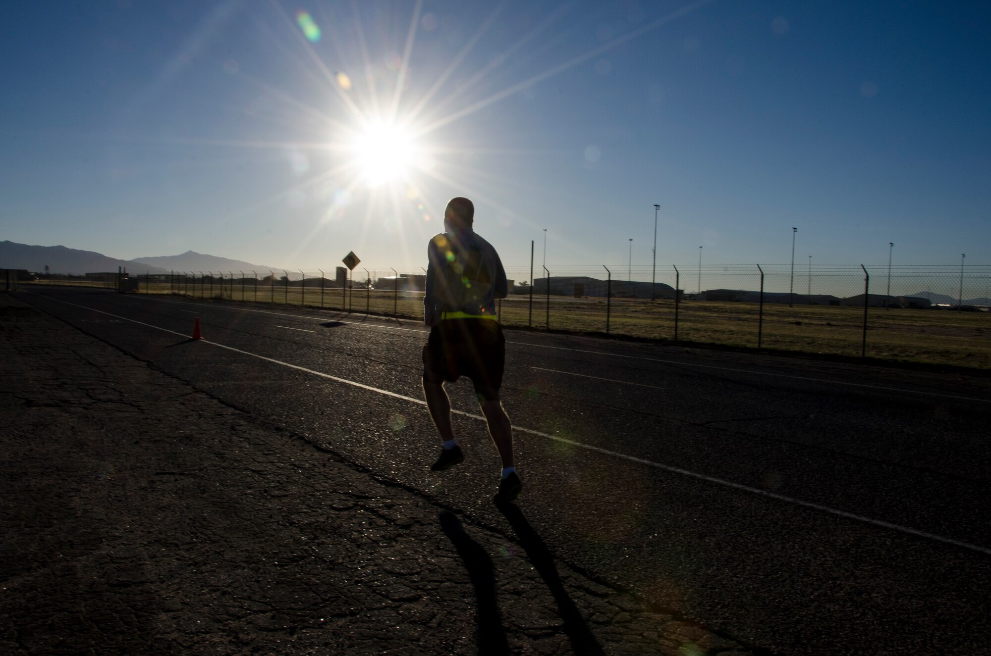A member of the 1st Battlefield Coordination Detachment finishes the run portion of the Army physical fitness test at Davis-Monthan AFB, Ariz.,  Nov. 4, 2014. Performance on the test  is strongly linked to a soldier's fitness level and his or her ability to do fitness related tasks. (U.S. Air Force photo by Staff Sgt. Adam Grant/Released)