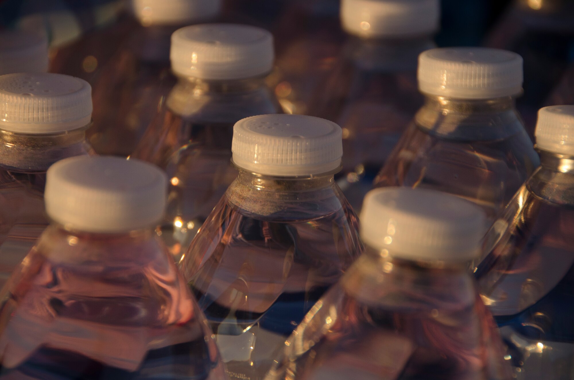 Bottles of water sit while members of the 1st Battlefield Coordination Detachment take the Army physical fitness test at Davis-Monthan AFB, Ariz., Nov. 4, 2014. After each portion of the three-event test, members received a 10 minute break and were able to hydrate. (U.S. Air Force photo by Staff Sgt. Adam Grant/Released)