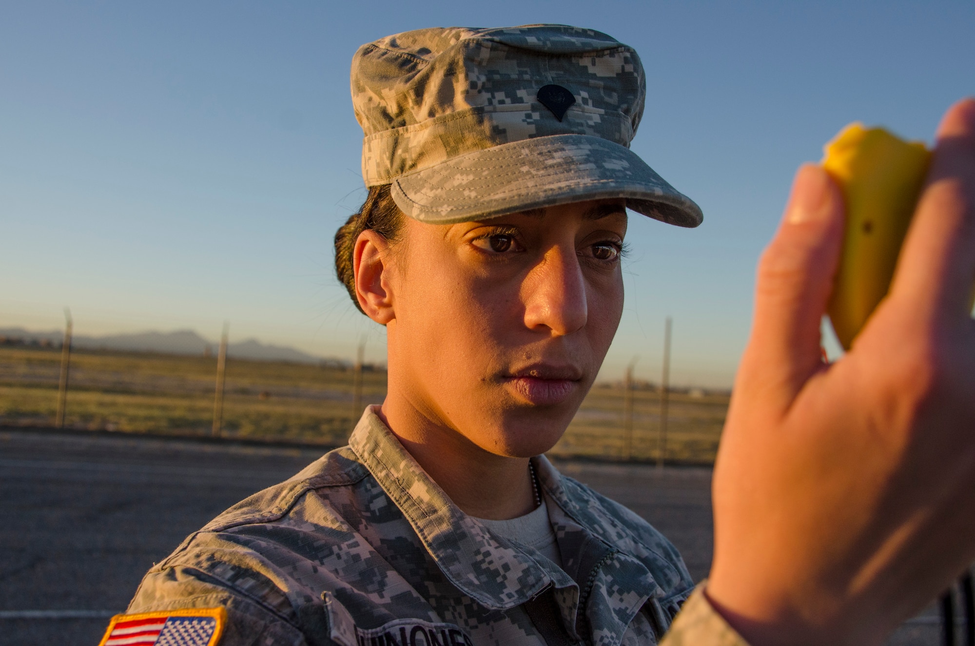 Spc. Yanira Quinones, 1st Battlefield Coordination Detachment Human Resources Specialists, keeps track of the amount of time left for members of the 1st BCD to complete the sit-up portion of the Army physical fitness test at Davis-Monthan AFB, Ariz., Nov. 4, 2014. The test is a way to measure a soldier's ability to effectively move his or her body by using their major muscle groups and cardiograms. (U.S. Air Force photo by Staff Sgt. Adam Grant/Released)