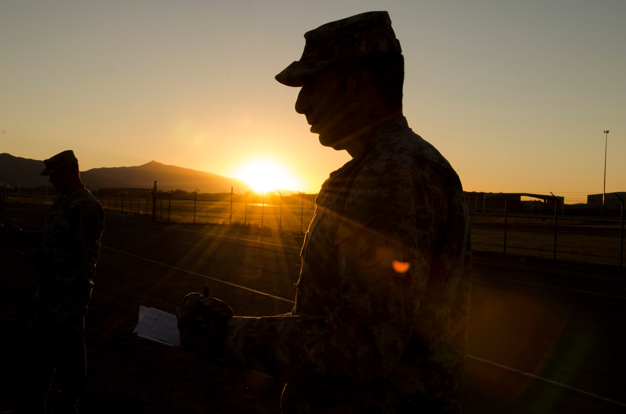 Staff Sgt. Parris Bussiere, 1st Battlefield Coordination Detachment Operations NCO, observes while members of the 1st BCD perform the push-up portion of the Army physical fitness test at Davis-Monthan AFB, Ariz., Nov. 4, 2014. The test is a three-event physical performance test used to assess muscular endurance and cardiograms fitness for all ages. (U.S. Air Force photo by Staff Sgt. Adam Grant/Released)