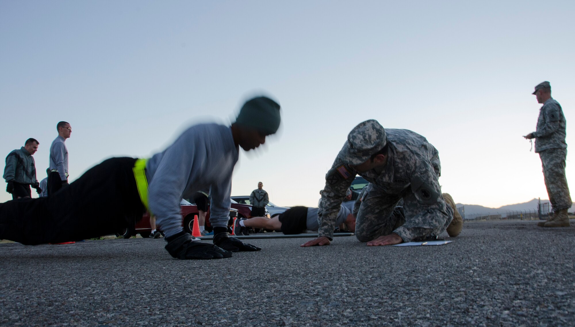 A member of the 1st Battlefield Coordination Detachment performs push-ups during the Army physical fitness test at Davis-Monthan AFB, Ariz., Nov. 4, 2014. Once all members have completed the push-up portion of the fitness test they will then move on to the sit-up portion. (U.S. Air Force photo by Staff Sgt. Adam Grant/Released)