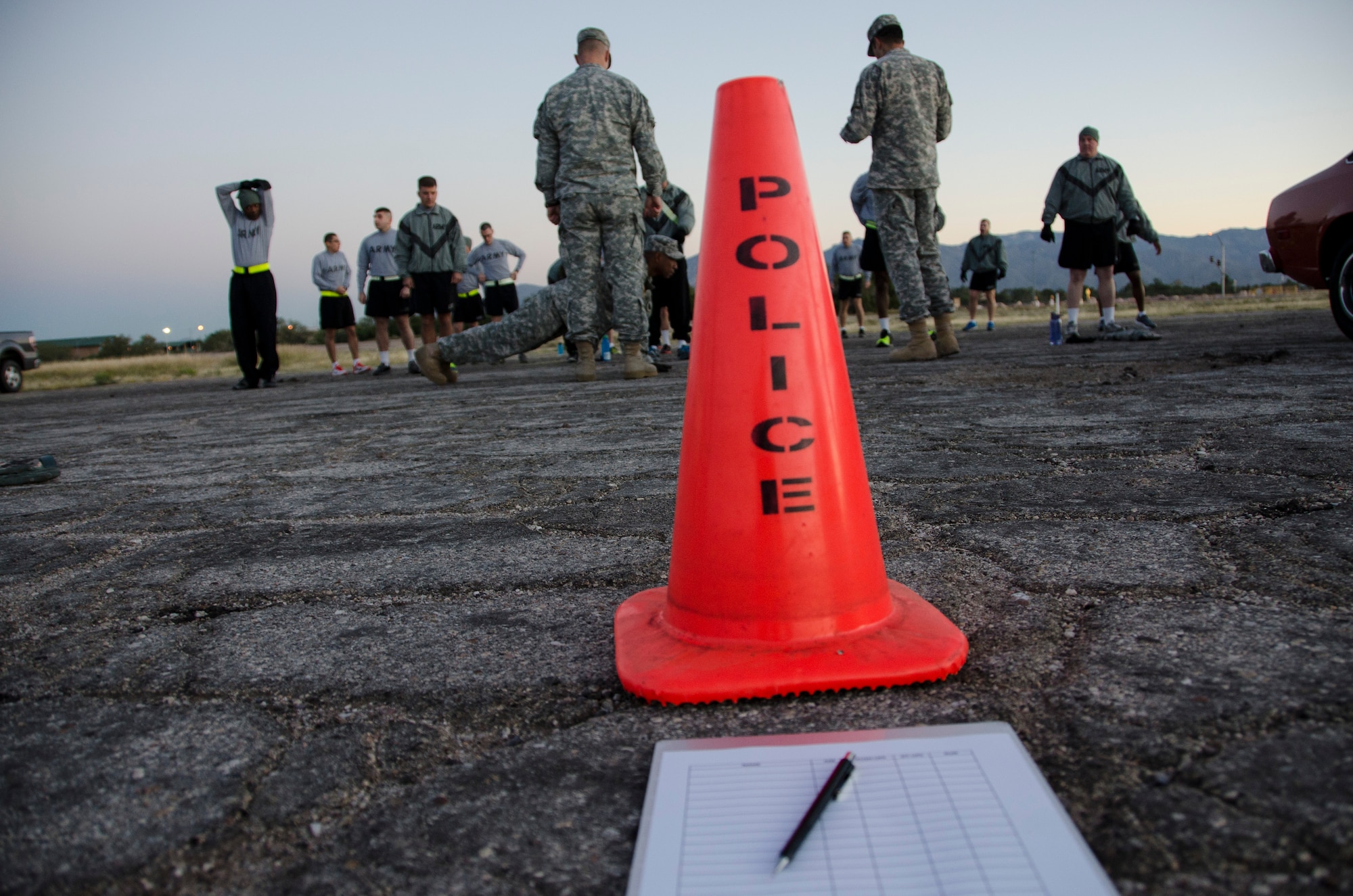 Members from the 1st Battlefield Coordination Detachment gather around and observe demonstrations on correct form before taking the Army physical fitness test at Davis-Monthan AFB, Ariz., Nov. 4, 2014.  All soldiers in the Active Army, Army National Guard, and Army Reserve are required to take the Army Physical Fitness Test. (U.S. Air Force photo by Staff Sgt. Adam Grant/Released)