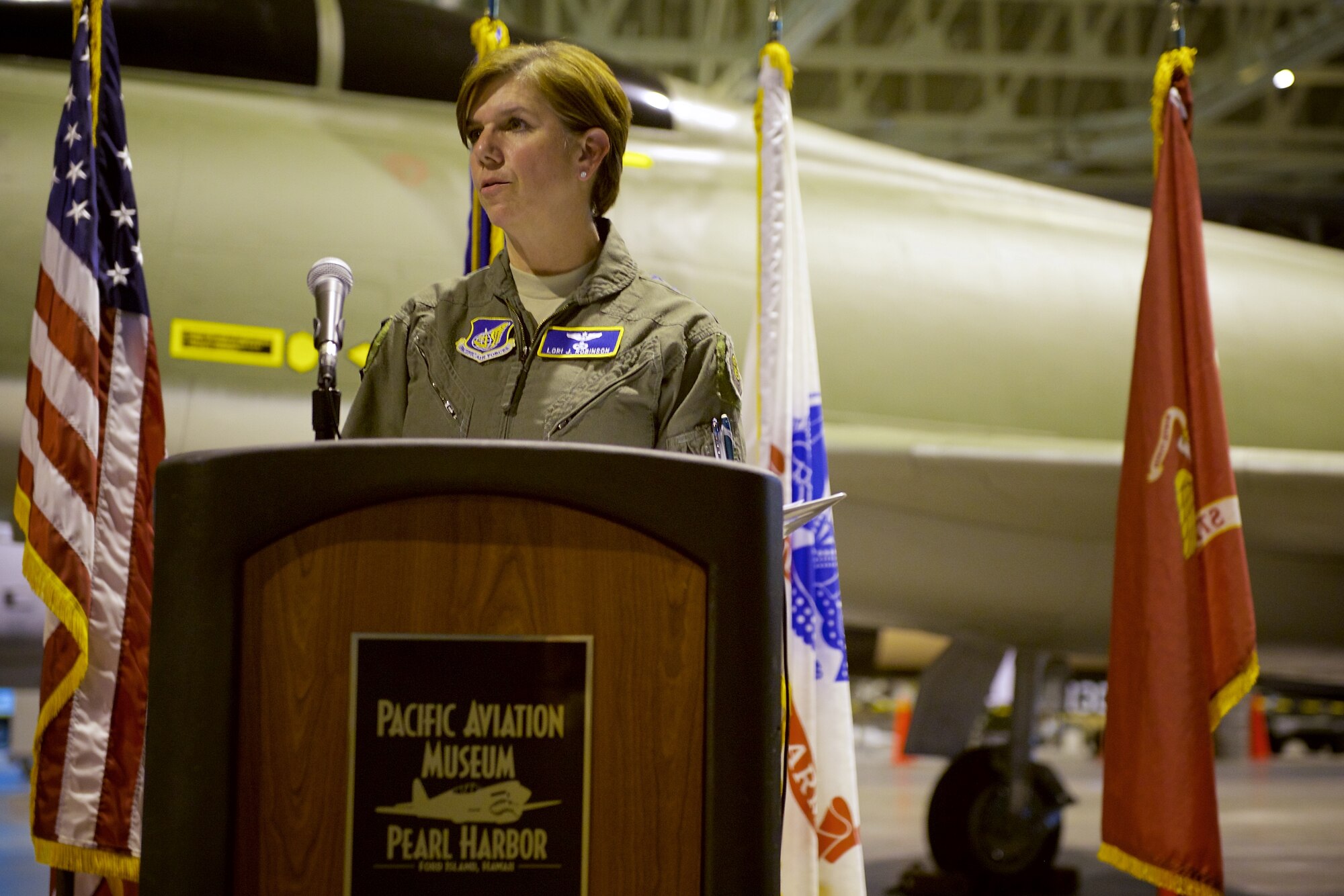 U.S. Air Force Gen. Lori J. Robinson, Pacific Air Forces commander, speaks during an F-100F Super Sabre aircraft dedication ceremony, Ford Island, Hawaii, Oct. 30, 2014.  The F-100F is a two-seat supersonic jet fighter used extensively by forward air controls during the Vietnam War.  The FACs, famously known by their call sign Misty, used specialized tactics and the fast F-100F to locate and mark targets for other aircraft to hit.  This F-100F was recently acquired and restored prior to its dedication at the Pacific Aviation Museum.  (U.S. Air Force by photo by Tech. Sgt. James Stewart/Released)