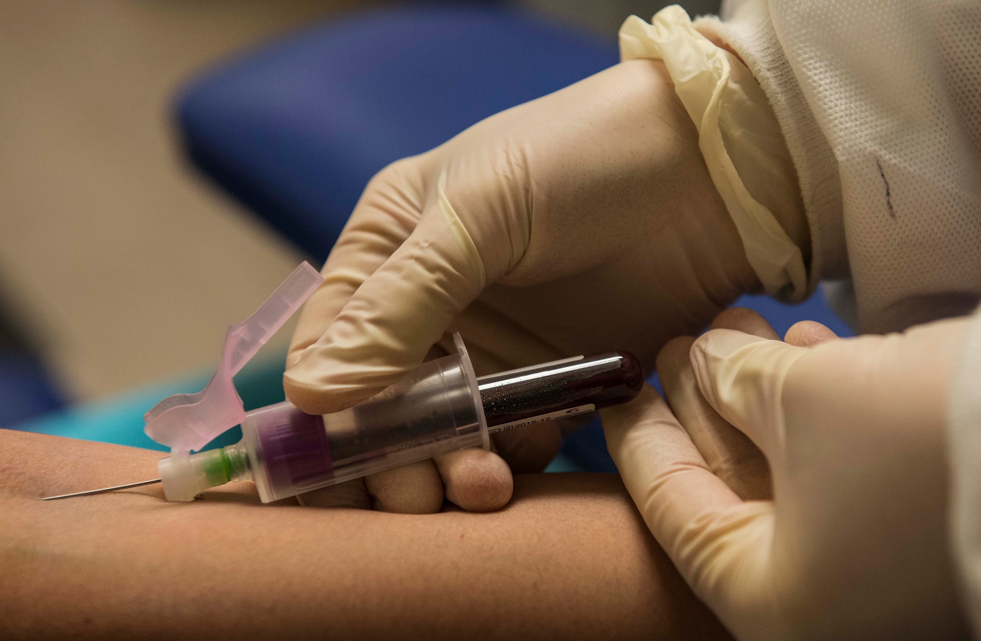 SSgt. Hollie Crawford, NCO in charge of the 5 MDG medical lab, prepares to draw a blood sample from a patient on Minot Air Force Base, N.D., Oct. 29, 2014. The medical labs are responsible for testing samples and relaying the results back to physicians to ensure base-wide health and safety. (U.S. Air Force photo/Airman 1st Class Lauren Pitts) 