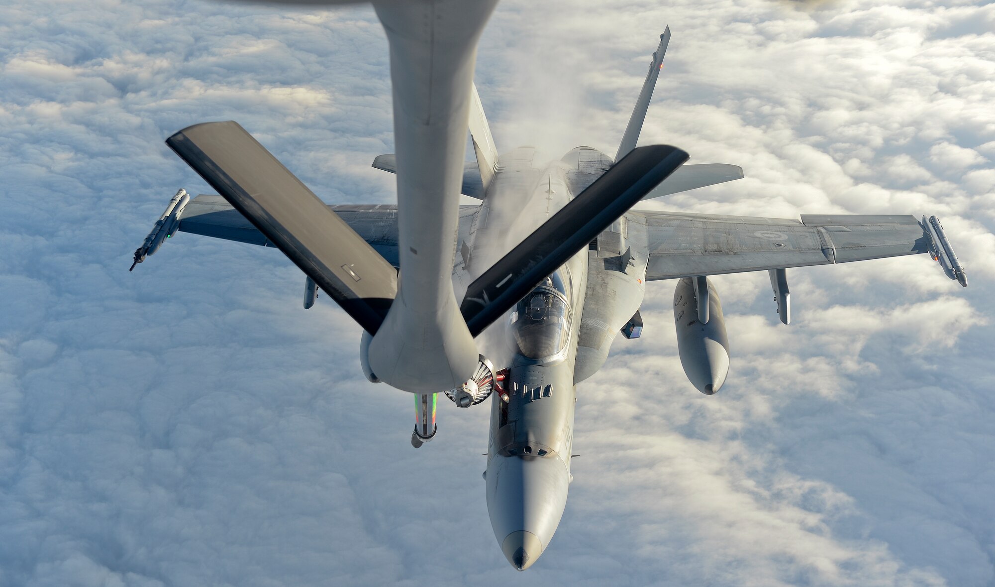 A CF-18 Hornet, 425 Tactical Fighter Squadron, is refueled by a KC-135 Stratotanker from McConnell Air Force Base, Kan., during exercise Vigilant Shield 15 at 5 Wing Goose Bay, Newfoundland and Labrador, Oct. 25, 2014. The Vigilant Shield field training exercise is a bi-national NORAD Command exercise which provides realistic training and practice for American and Canadian forces in support of respective national strategy for North America’s defense. NORAD ensures U.S. and Canadian air sovereignty through a network of alert fighters, tankers, airborne early warning aircraft, and ground-based air defense assets cued by interagency and defense surveillance radars. (U.S. Air Force photo by Airman 1st Class Colby L. Hardin/Released)