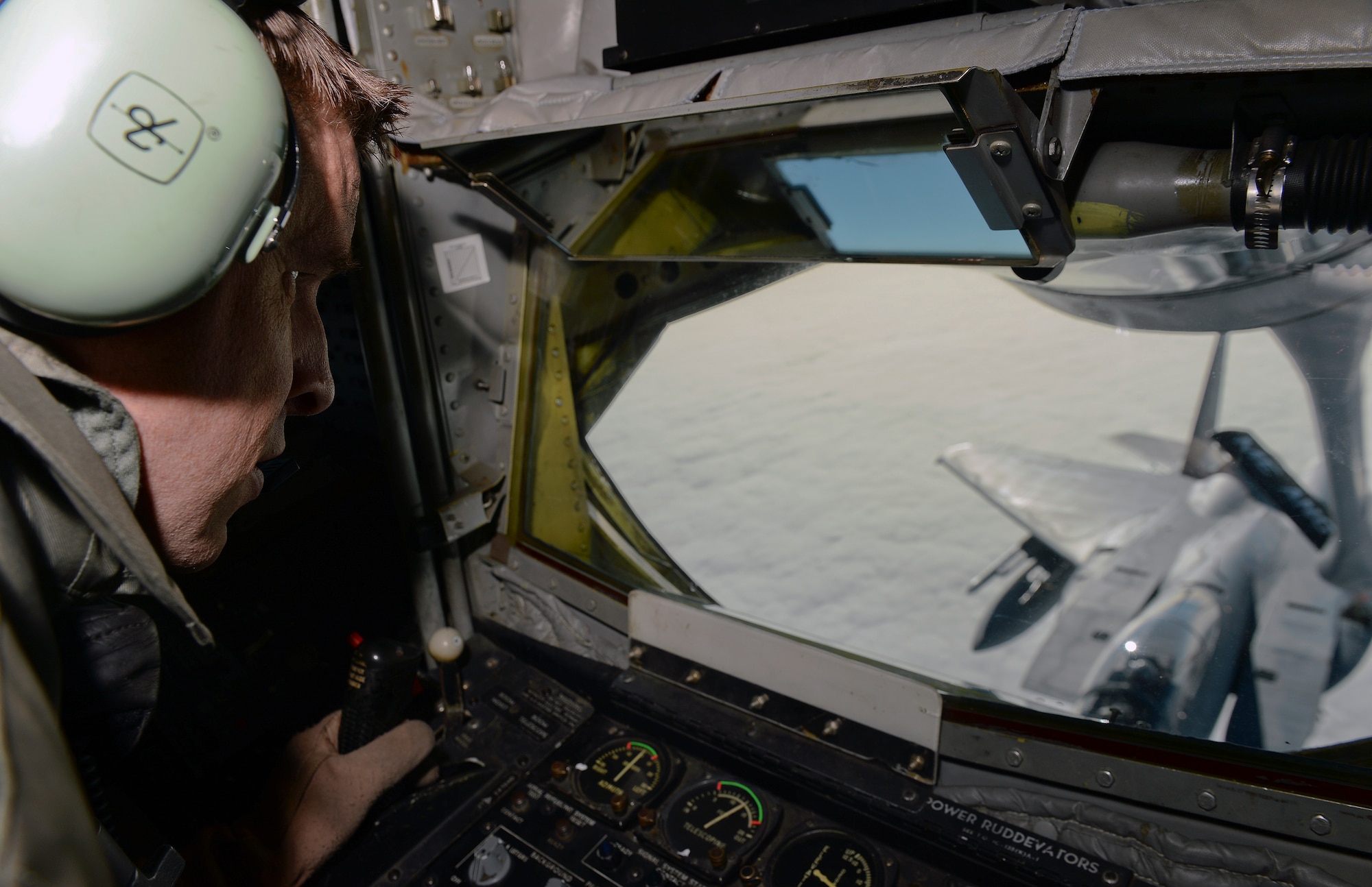 Tech. Sgt. Matt Ziegelbein, 18th Air Refueling Squadron boom operator, operates the boom while refueling an F-15 Eagle during exercise Vigilant Shield 15 at 5 Wing Goose Bay, Newfoundland and Labrador, Oct. 24, 2014. The Vigilant Shield field training exercise is a bi-national NORAD Command exercise which provides realistic training and practice for American and Canadian forces in support of respective national strategy for North America’s defense. NORAD ensures U.S. and Canadian air sovereignty through a network of alert fighters, tankers, airborne early warning aircraft, and ground-based air defense assets cued by interagency and defense surveillance radars. (U.S. Air Force photo by Airman 1st Class Colby L. Hardin/Released