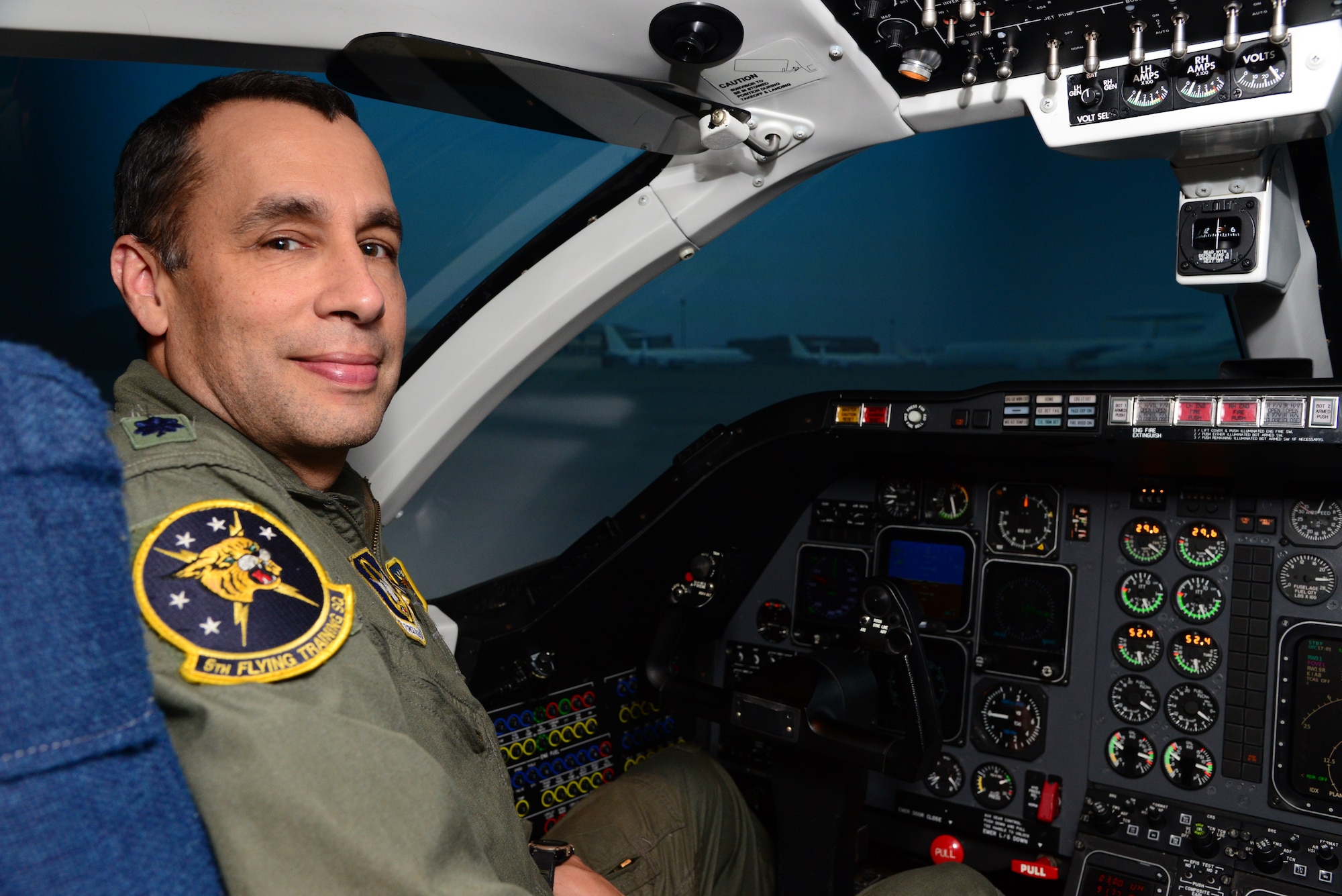 Lt. Col. Mark Lyons, a 5th Flying Training Squadron instructor pilot, sits in a T-1A Jayhawk flight simulator.  As part of the Energy Analysis Task Force, Lyons is teaching student pilots how to fly in a more fuel-efficient manner in flight simulators. The overarching goal of this training is to create an energy-aware culture in the Air Force, specifically in the flying community. (U.S. Air Force photo/Senior Airman Frank Casciotta)