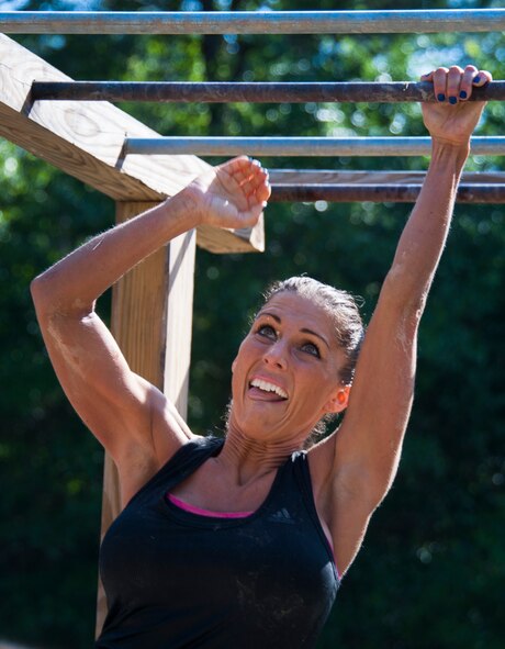 1st Lt. Bobbiejean Johnson, of the 919th Special Operations Wing, scales the monkey bars before the finish of the Emerald Coast MudRun for Orphans in Niceville Fla., May 17. Active duty and reserve service members came out to get dirty in either the morning or afternoon 5K challenges. The participants could run, crawl, climb, slide, and scale their way through this adventure race.  (U.S. Air Force photo/Tech. Sgt. Jasmin Taylor)