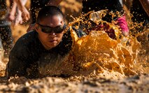 A competitor starts off the race with a splash at the beginning of the Emerald Coast MudRun for Orphans in Niceville Fla., May 17. Active duty and reserve service members came out to get dirty in either the morning or afternoon 5K challenges. The participants could run, crawl, climb, slide, and scale their way through this adventure race.  (U.S. Air Force photo/Tech. Sgt. Jasmin Taylor)