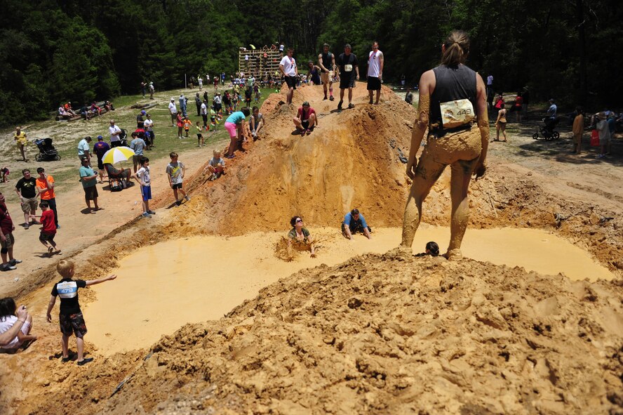 A member waits at the top of the mound for the rest of her team to catch up at the Emerald Coast MudRun for Orphans in Niceville Fla., May 17. Active duty and reserve service members came out to get dirty in either the morning or afternoon 5K challenges. The participants could run, crawl, climb, slide, and scale their way through this adventure race.  (U.S. Air Force photo/Tech. Sgt. Jasmin Taylor)
