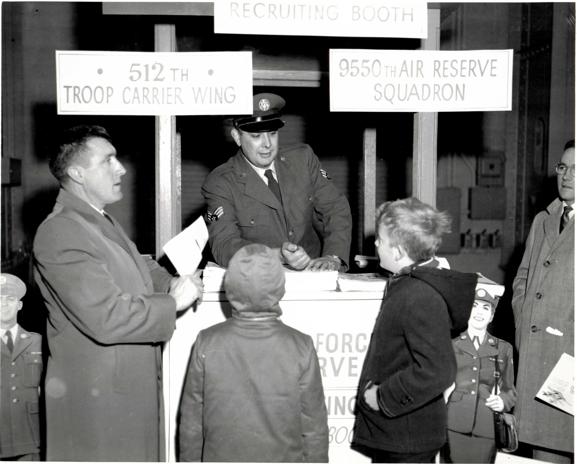 Members from the local community line up to speak with a 512th Troop Carrier Wing recruiter, in the late 1950's. The documentation and preservation of this rich history is the responsibility of Air Force Reserve Historians, who also prepare and present historical studies and papers that meet critical research standards. 