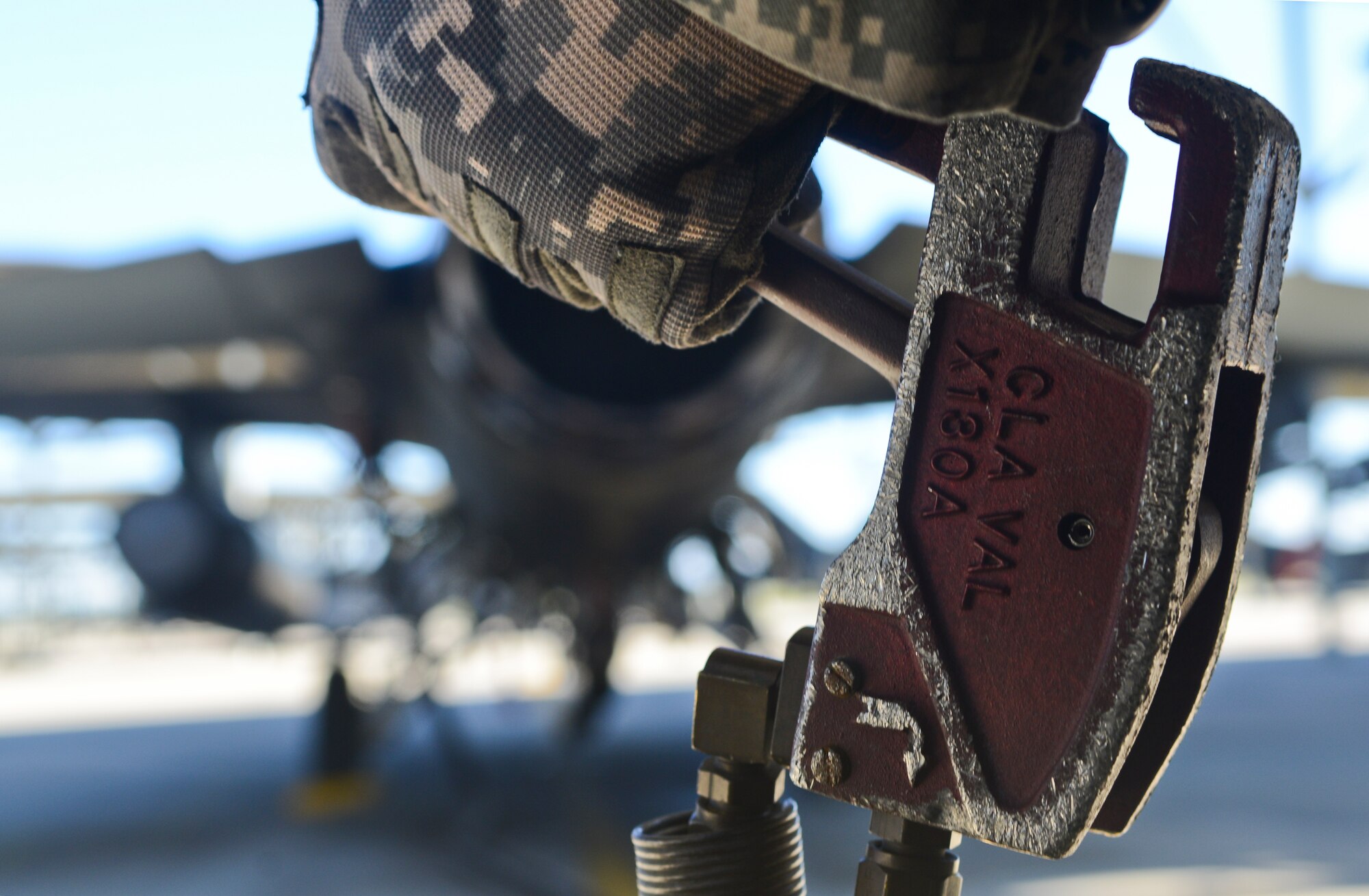 U.S. Air Force Senior Airman Samuel Sharrar, 20th Logistics Readiness Squadron fuels distribution operator, holds a pump handle as he refuels an F-16CM Fighting Falcon at Shaw Air Force Base, S.C., Oct. 30, 2014. The fuels shop keeps jets in the air by sustaining the fuels mission by providing fuel for combat-ready air power. (U.S. Air Force photo by Senior Airman Ashley L. Gardner/Released)