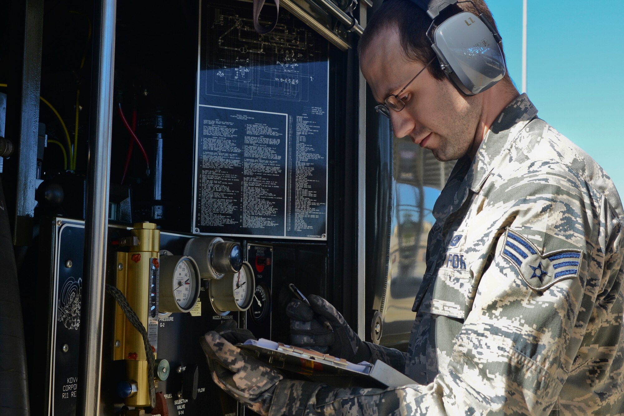U.S. Air Force Senior Airman Samuel Sharrar, 20th Logistics Readiness Squadron fuels distribution operator, regulates the fuel being pumped from a fuel truck into an F-16CM Fighting Falcon, Shaw Air Force Base, S.C., Oct. 30, 2014.  The fuels distribution section and the fuels lab work together to keep the base jet fuel supply at its highest quality. (U.S. Air Force photo by Senior Airman Ashley L. Gardner/Released)