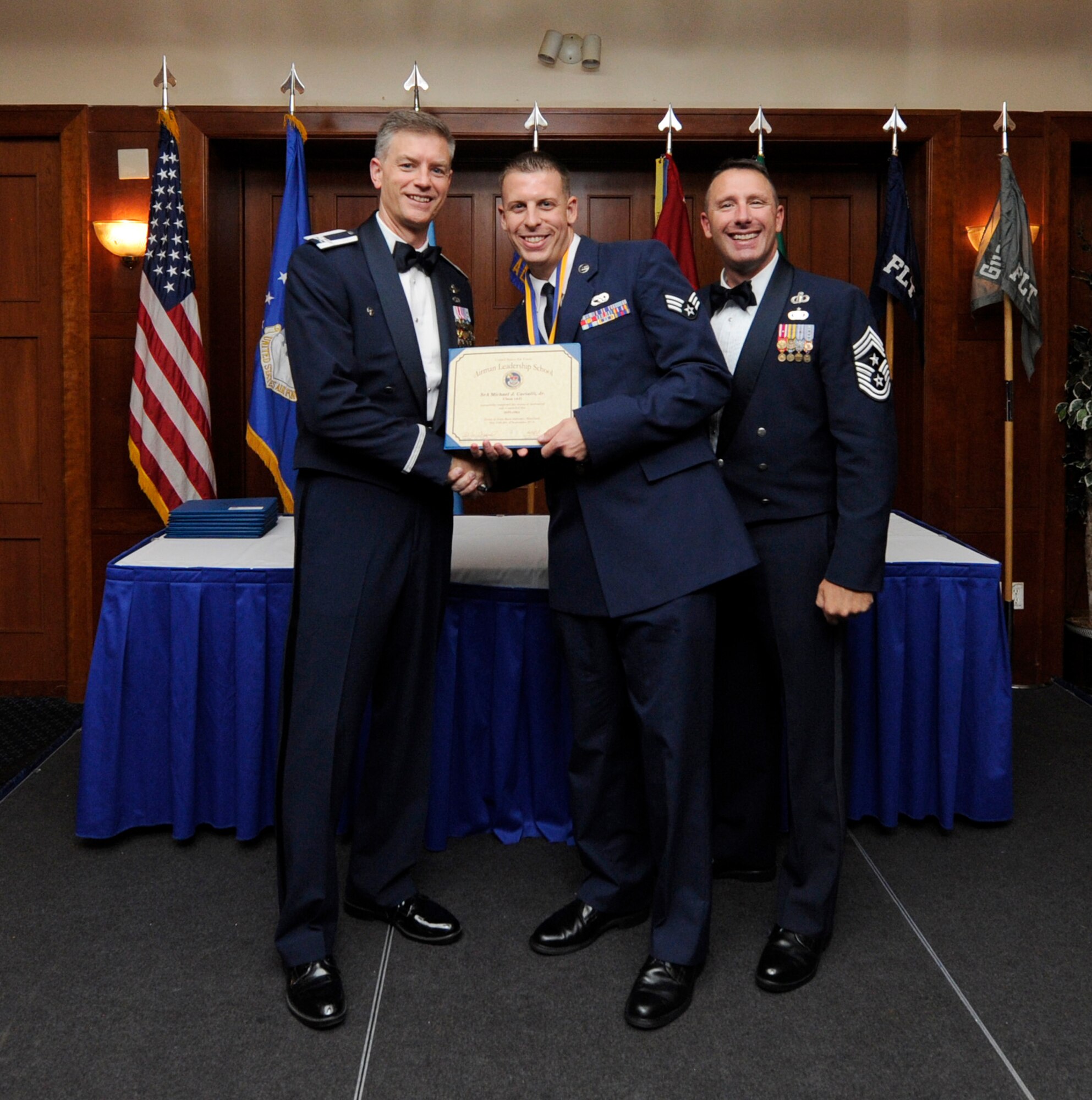 Airman Leadership School (ALS) is a five-week professional military education course which serves as the educational bedrock for new noncommissioned officers. Col. Daniel Waters, 11th Wing Vice Commander  and Chief Master Sgt. Vance Kondon, 11th Wing Command Chief present Sr. Airman Delton McClary, from 779th Medical Group Medical Operations Squadron, with his ALS Graduation Certificate. (AF File Photo)