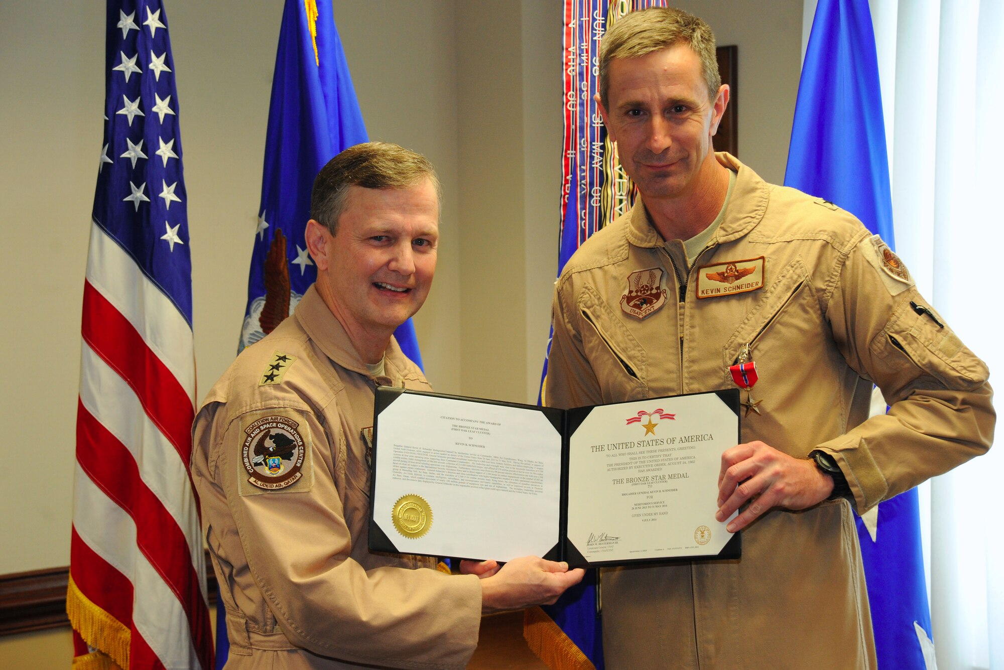 Lt. Gen. John Hesterman, Air Forces Central Command commander, presents a Bronze Star medal to Brig. Gen. Kevin Schneider, AFCENT assistant deputy commander, during a ceremony at Shaw Air Force Base, S.C., Oct. 28, 2014. Schneider received the award for his service as commander of the 380th Air Expeditionary Wing in Southwest Asia from June 2013 to June 2014. (U.S. Air Force photo by Airman 1st Class Michael Cossaboom/Released)