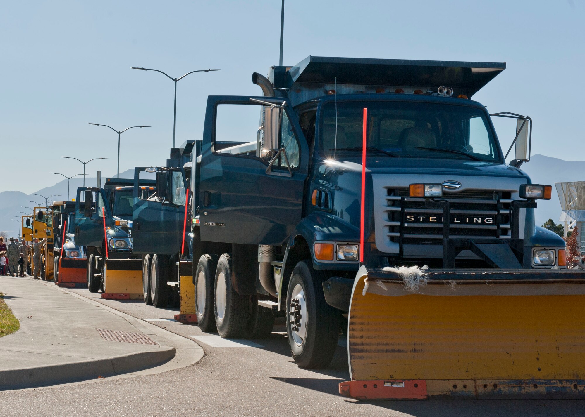 PETERSON AIR FORCE BASE, Colo. – Dump trucks and snow plows line the street during the annual Snow Parade for viewing by the children at the main Child Development Center Oct. 28. The Snow Parade was put on by the 21st Civil Engineer Squadron to familiarize and show off the snow plows, dump trucks, fire trucks and other equipment to base personnel and their families. The children also were able to hang out with Santa who rode in on a fire truck to greet them. (U.S. Air Force photo/Airman 1st Class Rose Gudex)