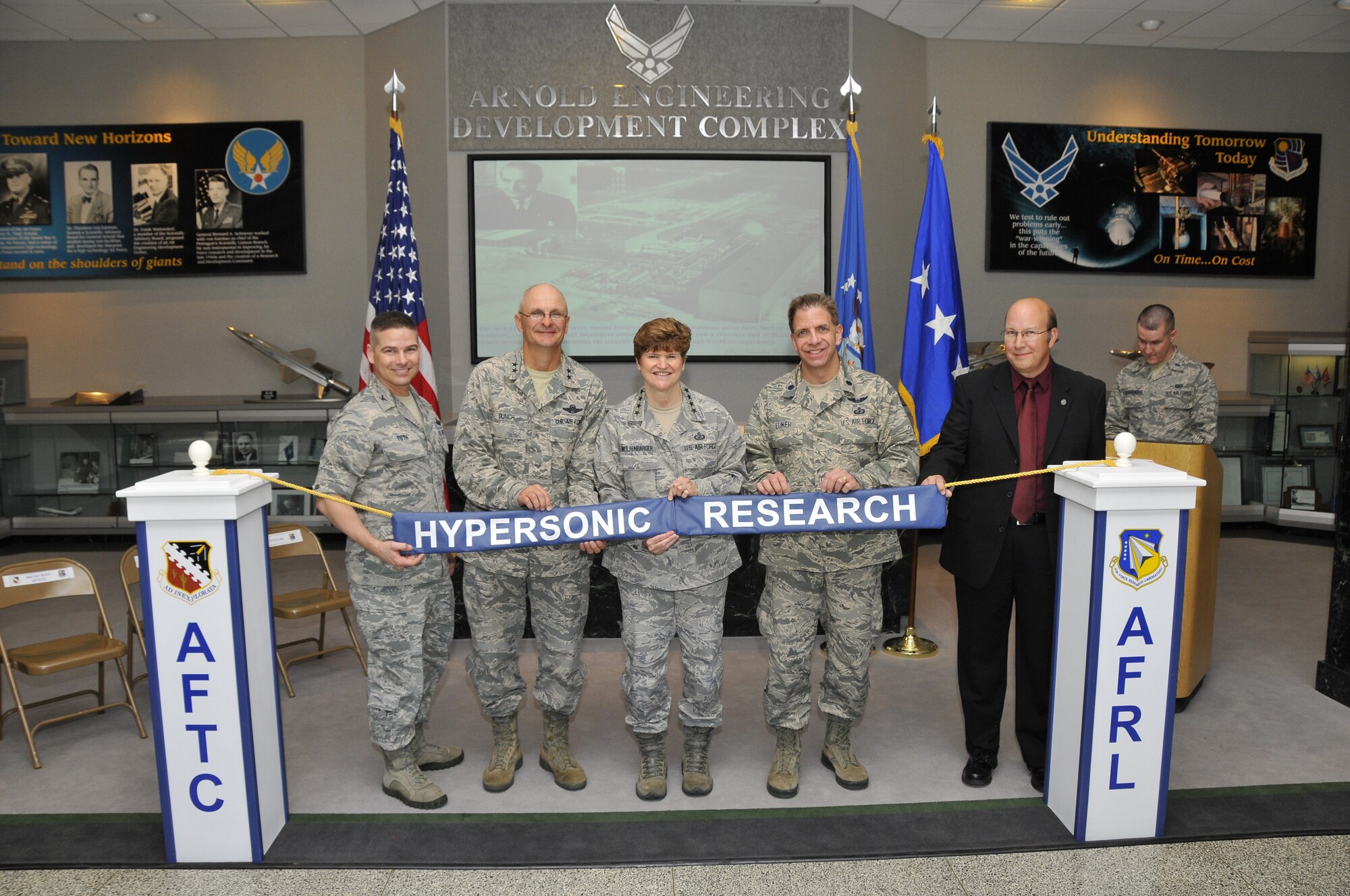 A recent ribbon-joining ceremony was held in celebration of a recent venture between Arnold Engineering Development Complex (AEDC) and the U.S. Air Force Research Laboratory (AFRL). AEDC is now the site of the AFRL High Speed Experimentation Branch, where efforts will focus on foundational and systems research in propulsion, aeronautics and structural applications related to hypersonic flight. Glenn Liston, advisor of AFRL High Speed Systems Science and Technology, is heading the branch. Pictured left to right are AEDC Commander Col. Raymond Toth, Air Force Test Center Commander Maj. Gen. Arnold Bunch, Jr., Air Force Materiel Command Commander Gen. Janet Wolfenbarger, Lt. Col. Joel Luker and Glenn Liston. (Photo by Rick Goodfriend)