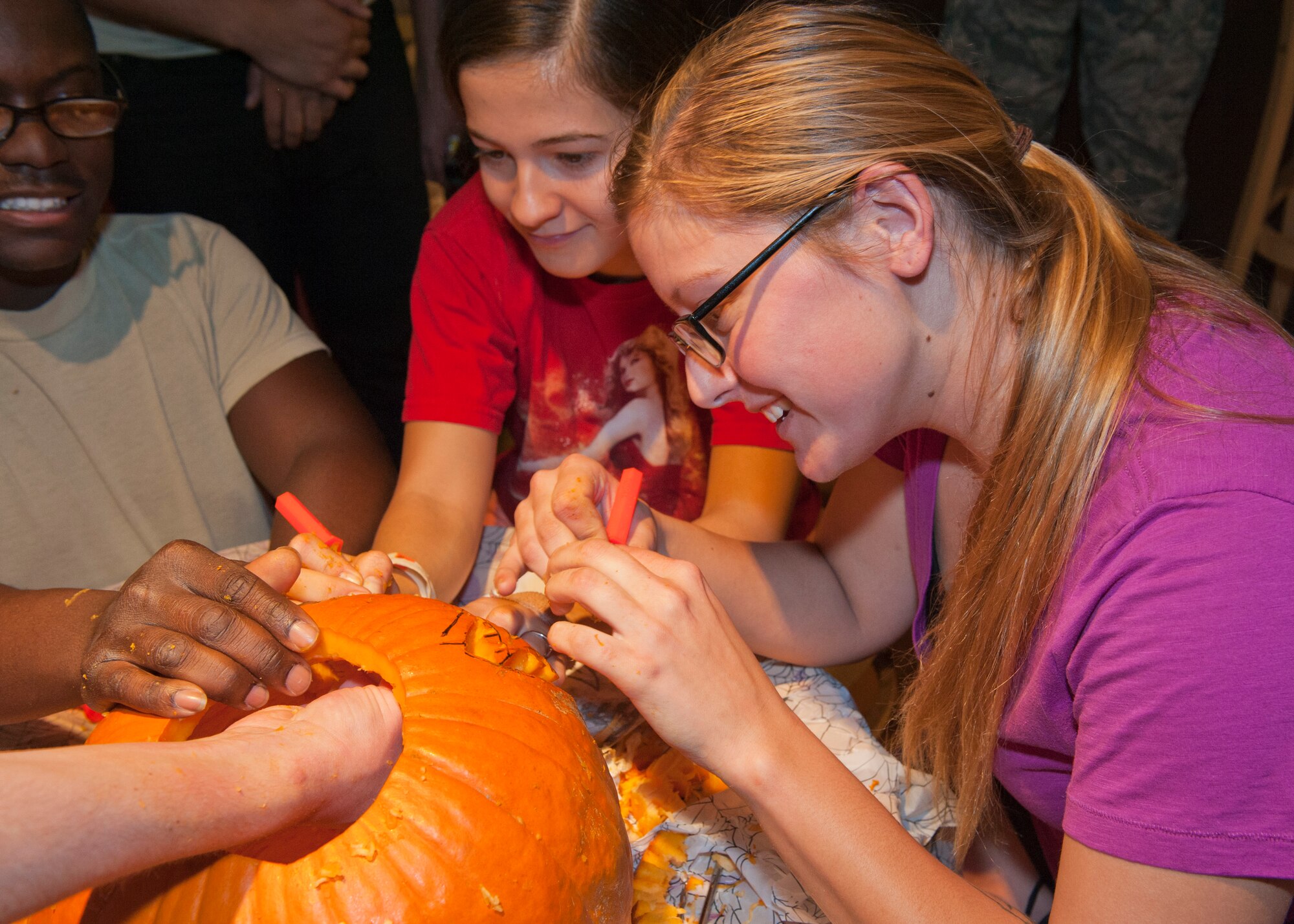 PETERSON AIR FORCE BASE, Colo. – Teams worked quickly to carve their pumpkins at the second annual pumpkin carving contest at the Cyber Café Oct. 29. Five teams participated in the contest sponsored by the Peterson AFB Chapel. The team comprised of Airmen 1st Class Sherman Good, Julieth Collazos, Mickey Szabat and Bridget Gray won the contest, with each member receiving a gift card. (U.S. Air Force photo/Airman 1st Class Rose Gudex)