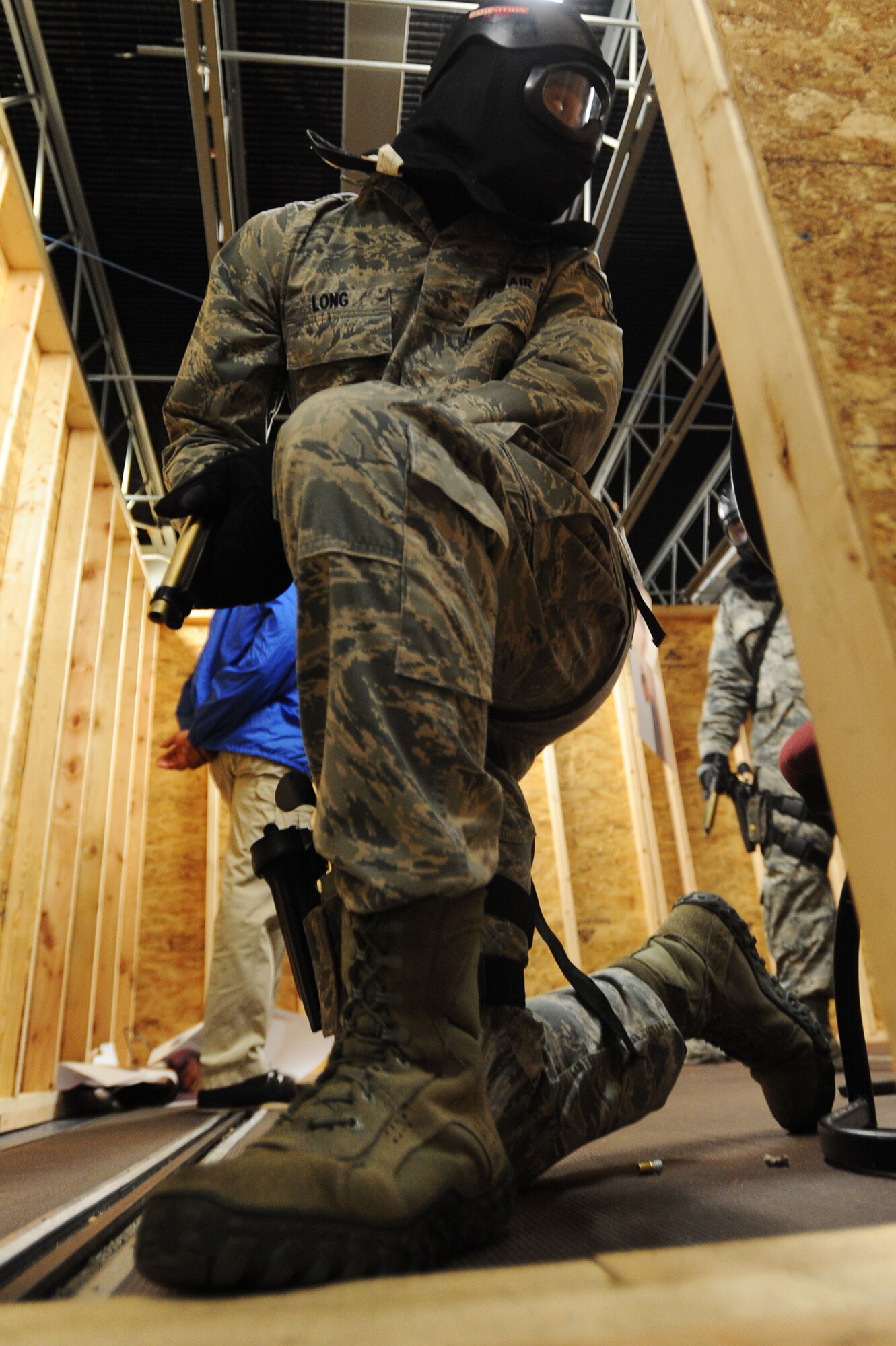A U.S. Air Force Airman assigned to the 20th Security Forces Squadron guards a door during an active shooter training session at Shaw Air Force Base, S.C., Oct. 29, 2014. Airmen entered the building in four-man teams, apprehended an active shooter, rescued hostages inside, and secured the building. (U.S. Air Force photo by Airman 1st Class Michael Cossaboom/Released)