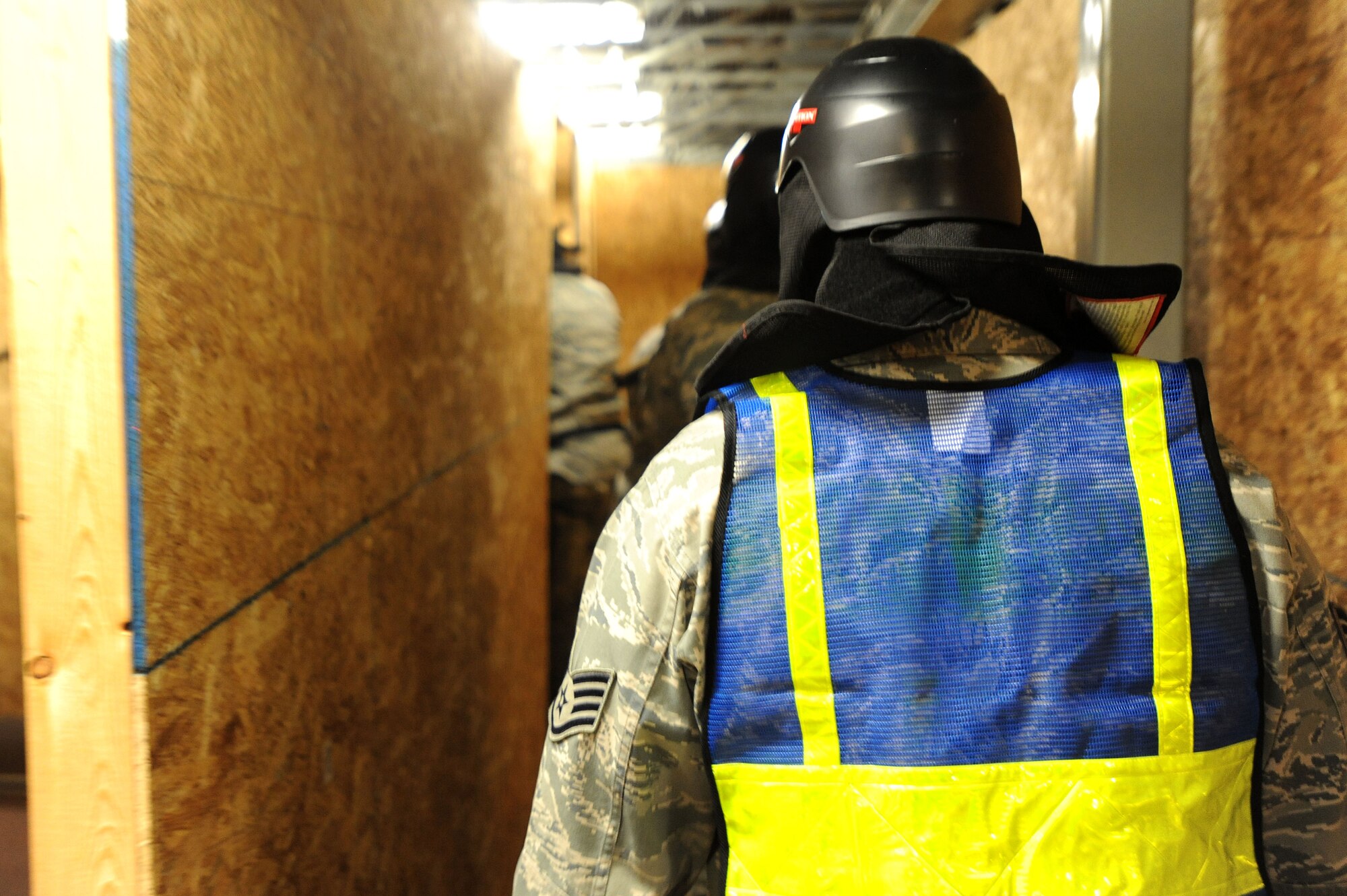 U.S. Air Force Staff Sgt. Edward Leslie, 20th Security Forces Squadron standards and evaluation technician, follows a group of Airmen through an active shooter training session at Shaw Air Force Base, S.C., Oct. 29, 2014. Leslie follows the Airmen throughout the building to ensure they use proper technique, movements, and perform proper actions. (U.S. Air Force photo by Airman 1st Class Michael Cossaboom/Released)