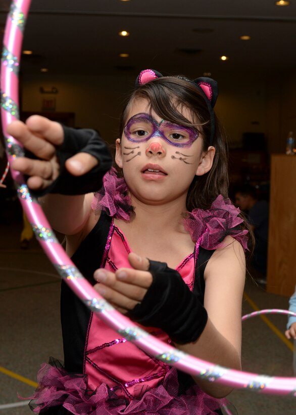 Emma Redstar, age 9, participates in a hula-hoop contest during the Harvest Festival hosted by the base chapel inside the Chapel Activities Center at Ellsworth Air Force Base, S.D., Oct. 29, 2014. Over 30 children with their families attended the Harvest Festival to celebrate the fall season and Halloween together. (U.S. Air Force photo by Senior Airman Anania Tekurio/Released)