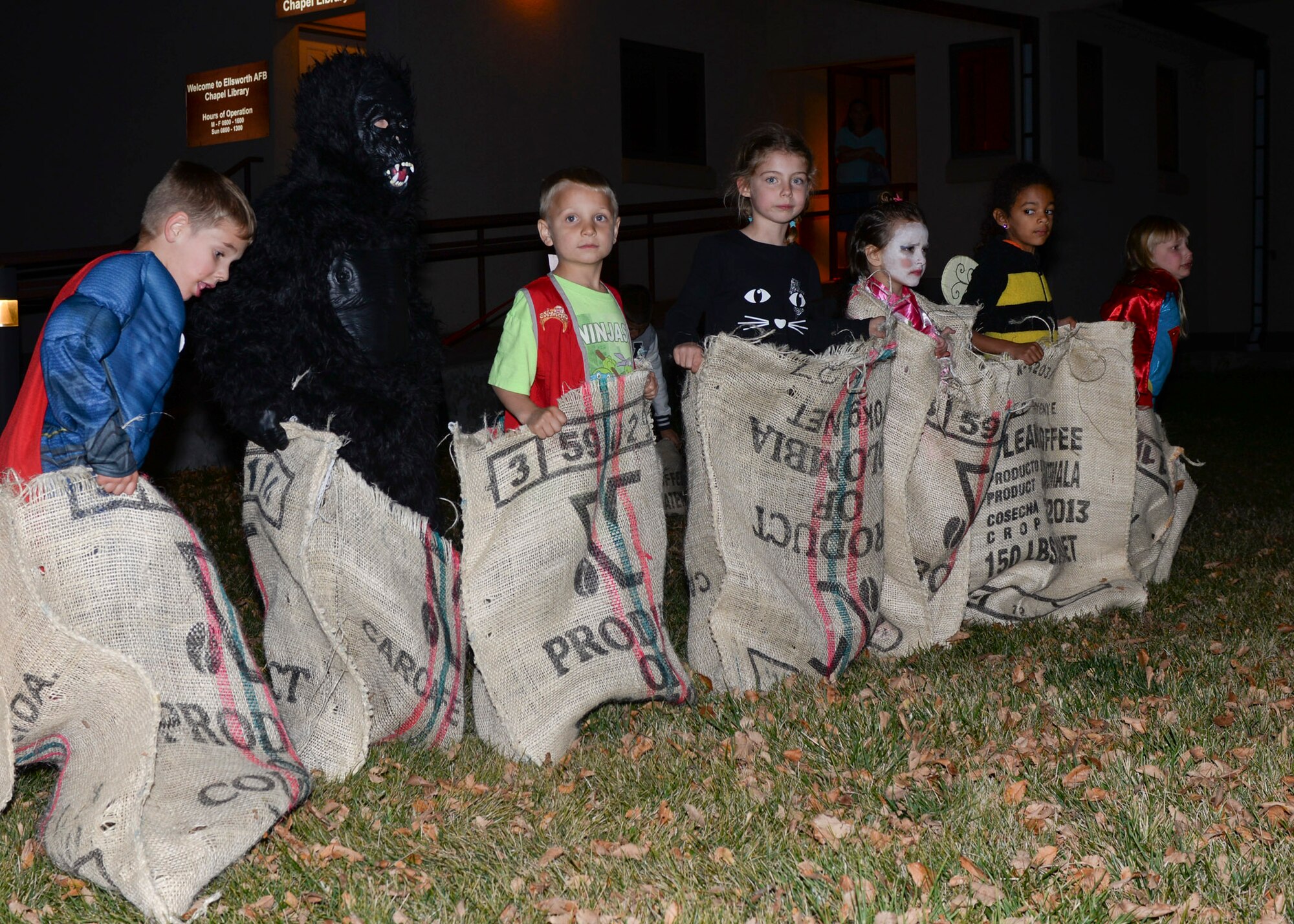 Children dressed in Halloween costumes participate in a potato sack race during the base chapel’s Harvest Festival at the Chapel Activities Center at Ellsworth Air Force Base, S.D., Oct. 29, 2014. In addition to potato sack races, children were also able participate in bowling and hula-hoop, and have their face painted. (U.S. Air Force photo by Senior Airman Anania Tekurio/Released)