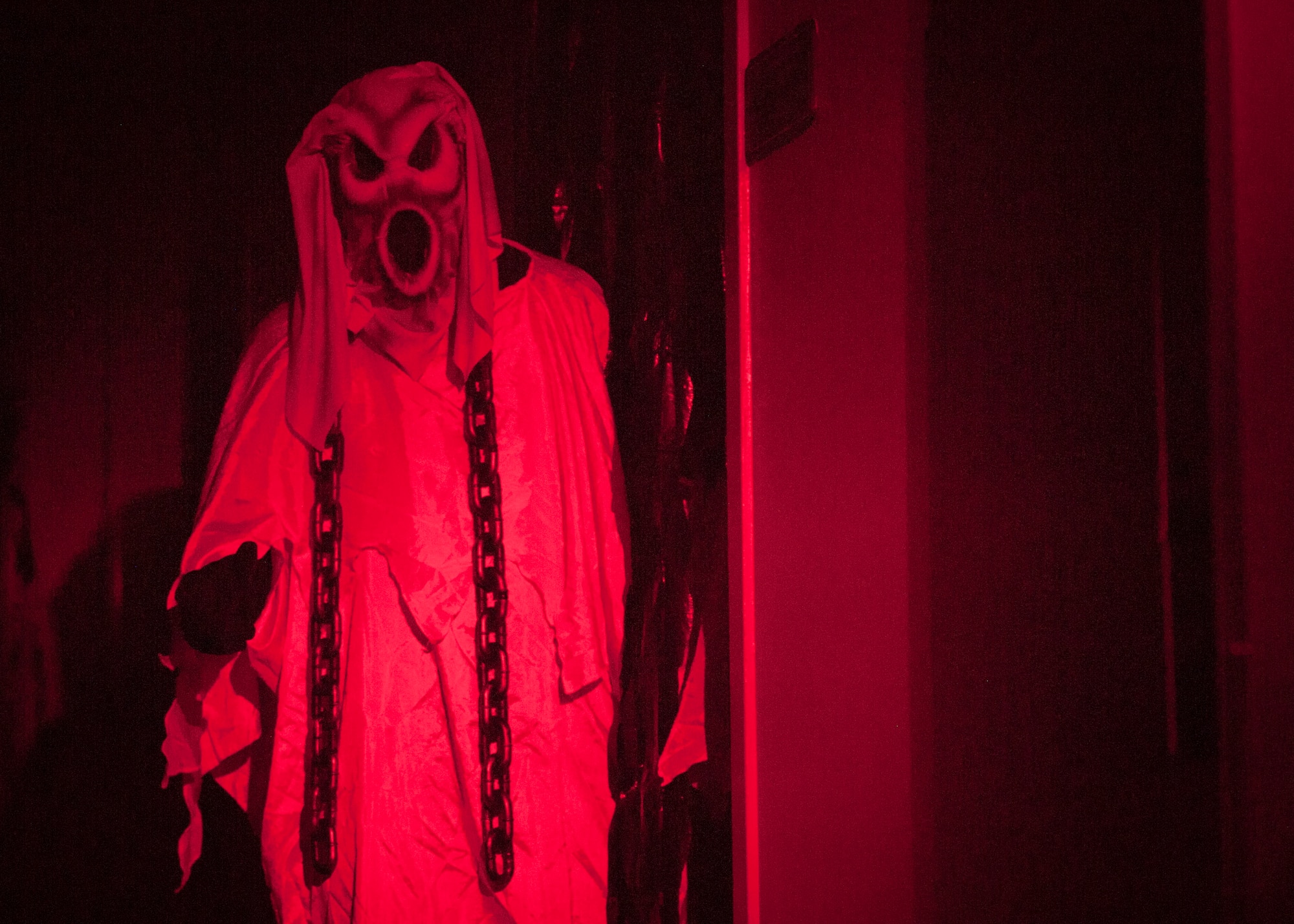 PETERSON AIR FORCE BASE, Colo. – A ghost waits in the shadows to scare the next group that dares to enter the 21st Communications Squadron haunted house Oct. 30. This was the first-ever haunted house put on by the 21st CS, and admission was free. Different rooms had different levels of “scare factor,” including a separate kid’s area for those that weren’t quite ready to be scared. (U.S. Air Force photo/Airman 1st Class Rose Gudex)