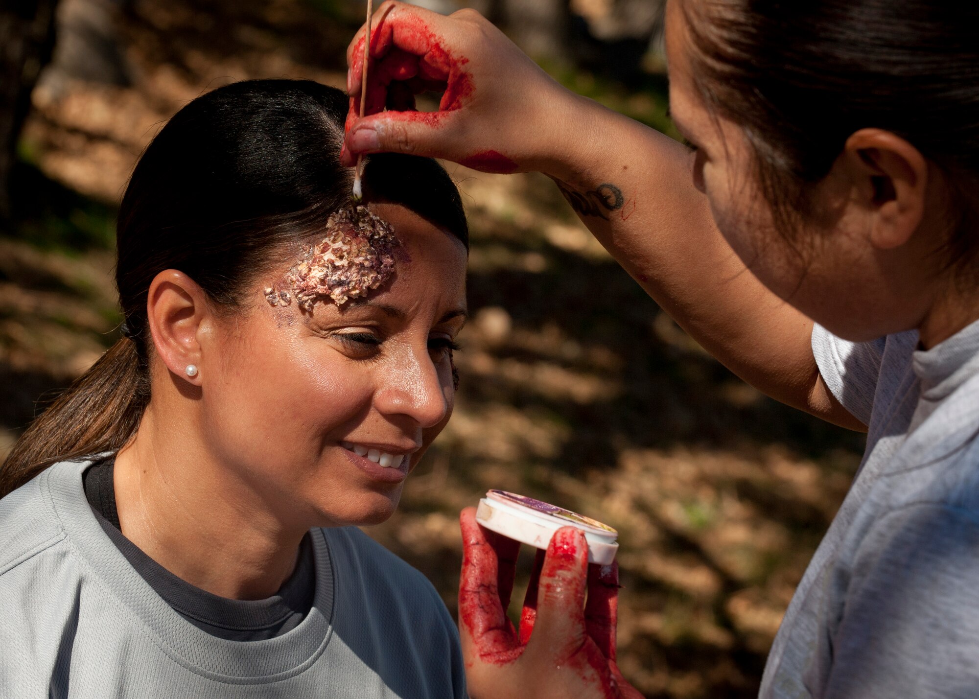 CHEYENNE MOUNTAIN AIR FORCE STATION, Colo. – Chief Master Sgt. Idalia Peele, 21st Space Wing command chief, gets moulage done to fit in with the zombie crowd at the Zombie Tunnel 5k Fun Run at Cheyenne Mountain Oct. 30. The Zombie Run was open to any military member and their family from Peterson Air Force Base, Schriever AFB, the U.S. Air Force Academy and Fort Carson. (U.S. Air Force photo/Staff Sgt. J. Aaron Breeden)