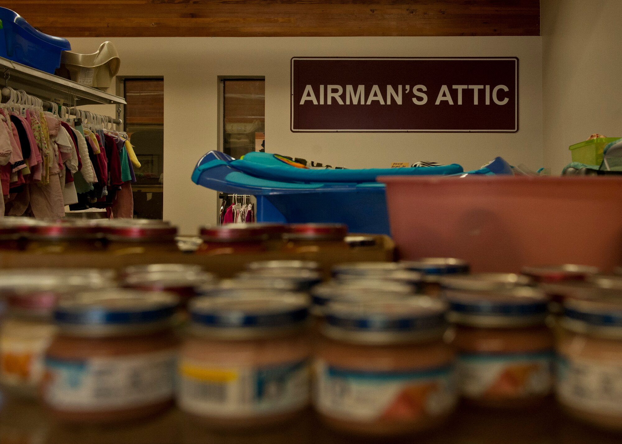 PETERSON AIR FORCE BASE, Colo. – The sign from the old location hangs on the wall as a reminder of where they started and how far they’ve come at the Airman’s Attic. The Airman’s Attic is a place where Airmen in grades E-5 and below can get household goods, clothes, children’s toys and miscellaneous items for free. Military uniforms are also available for free to all ranks. (U.S. Air Force photo/Airman 1st Class Rose Gudex)