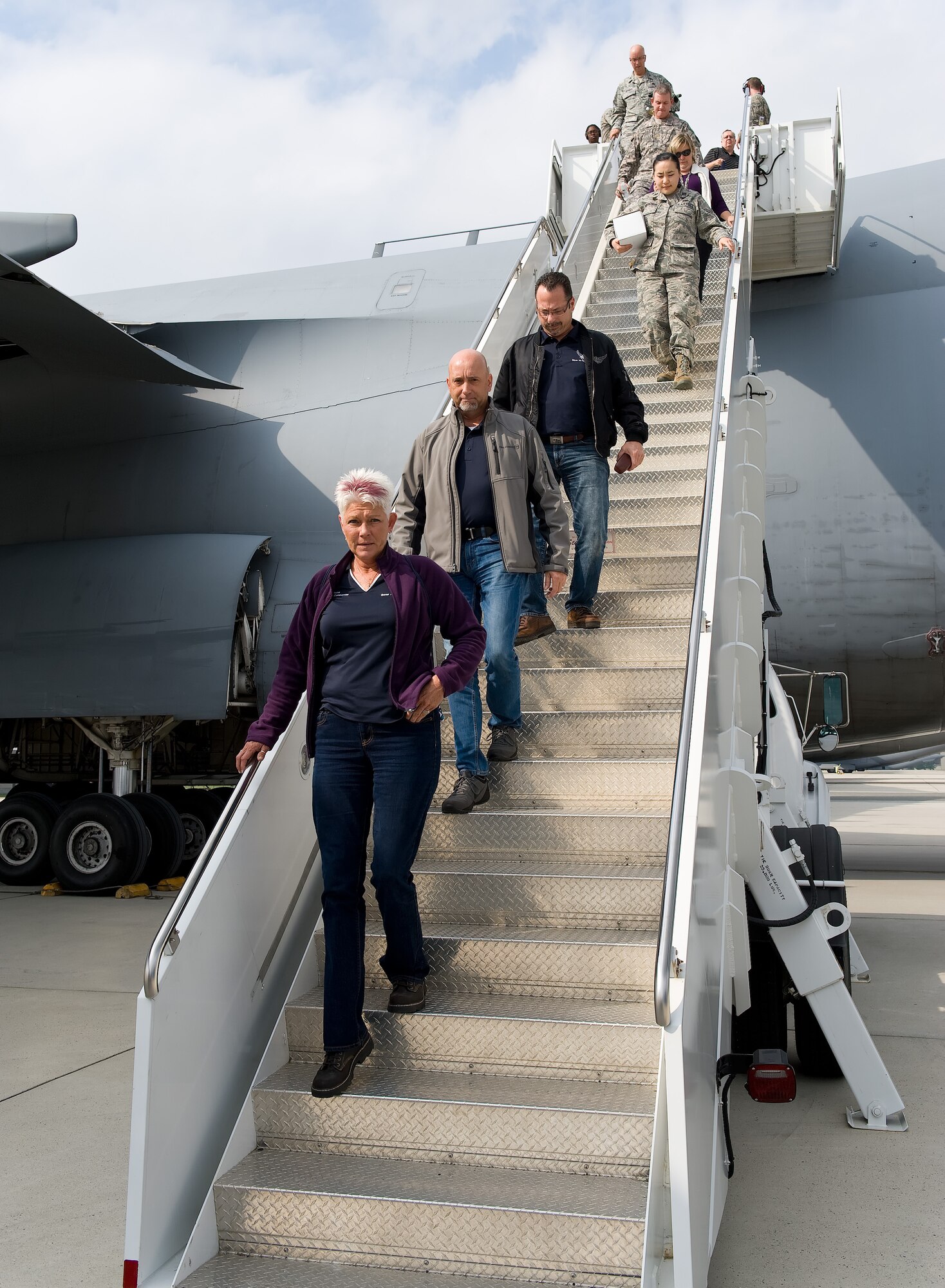 Honorary commanders Dawne Nickerson-Banez, 436th Logistics Readiness Squadron; Tom Banez, 436th Aerial Port Squadron; and John Yoho, 436th Maintenance Group, front to rear respectively, walk down the stairs leading from the troop compartment of a C-5M Super Galaxy  Oct. 29, 2014, at Dover Air Force Base, Del. Seventeen Team Dover honorary commanders went on a 2.7 hour flight that included air refueling with two Pennsylvania Air National Guard KC-135T Stratotankers from the 171st Air Refueling Wing, Pittsburgh International Airport, Pa. (U.S. Air Force photo/Roland Balik)