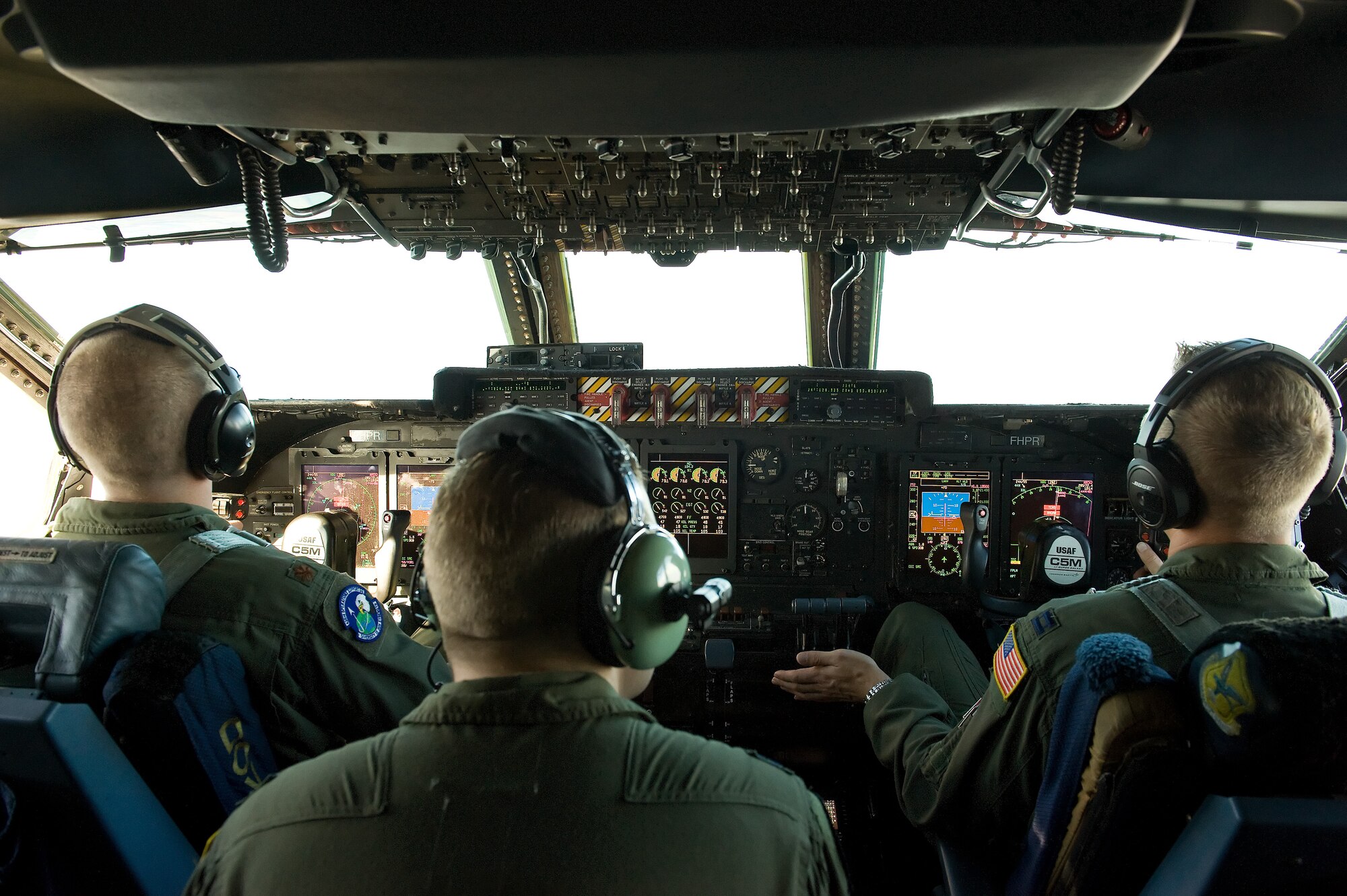 C-5M pilots Maj. Brandon Stock, 436th Operations Support Squadron deputy chief of current operations, left; Capts. Phillip Amrine, center, and Neal Ballas, right, both assigned to the 9th Airlift Squadron, Dover Air Force Base, Del., slowly approach a KC-135T Stratotanker from behind during an air refueling training flight Oct. 29, 2014. Seventeen honorary commanders went on the flight and observed the aerial refueling with two Pennsylvania Air National Guard KC-135T Stratotankers from the 171st Air Refueling Wing, Pittsburgh International Airport, Pa. (U.S. Air Force photo/Roland Balik)