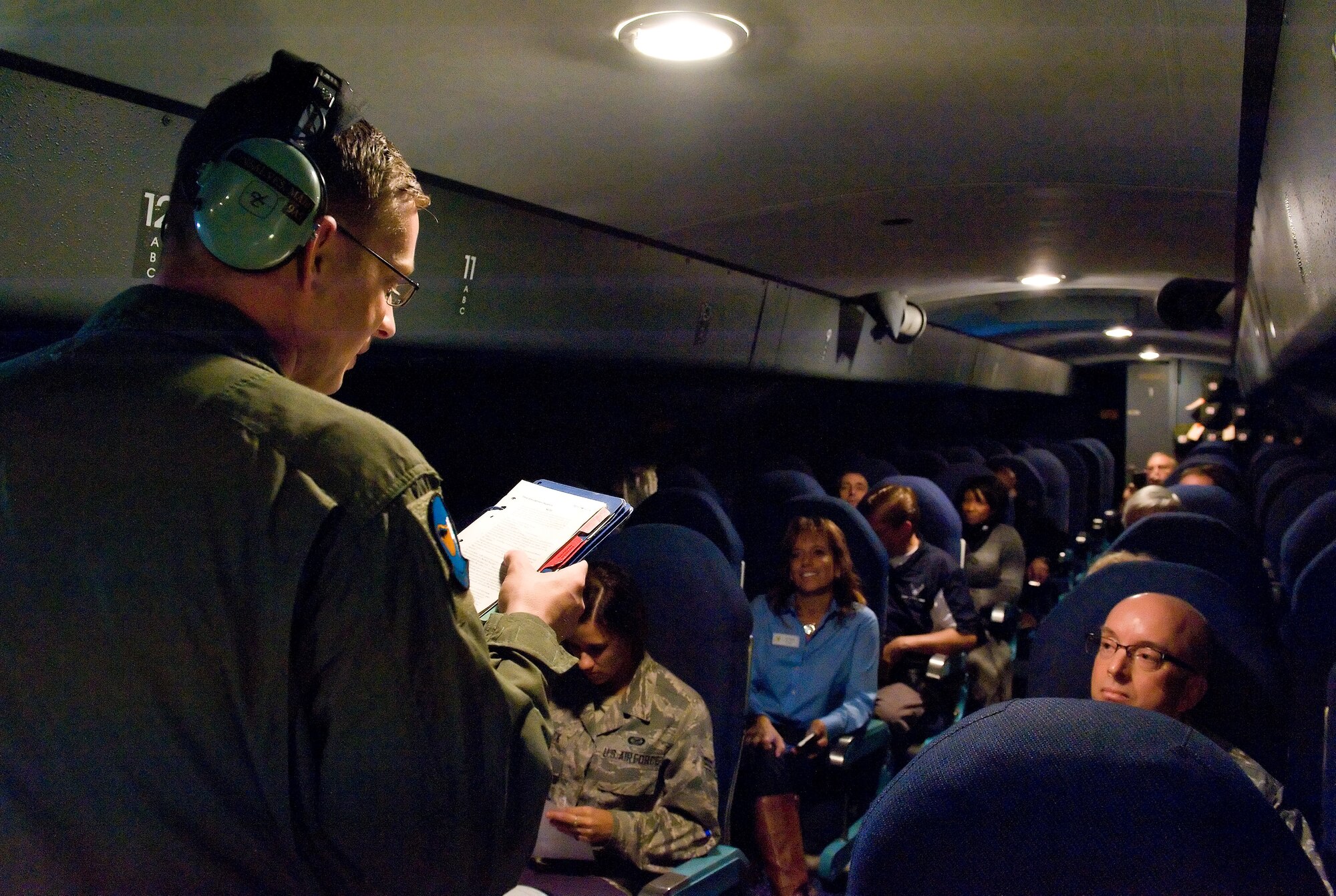 Master Sgt. Marc Gonsalves, 9th Airlift Squadron loadmaster, gives a safety briefing to Team Dover honorary commanders, unit commanders and public affairs ambassadors sitting in the troop compartment of a C-5M Super Galaxy prior to takeoff Oct. 29, 2014, at Dover Air Force Base, Del. Gonsalves briefed personnel on oxygen mask use, inflatable life vest donning and emergency exit locations within the troop compartment. (U.S. Air Force photo/Roland Balik)